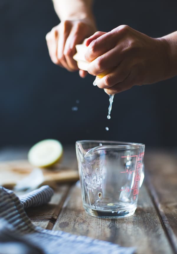 squeezing juice into jug