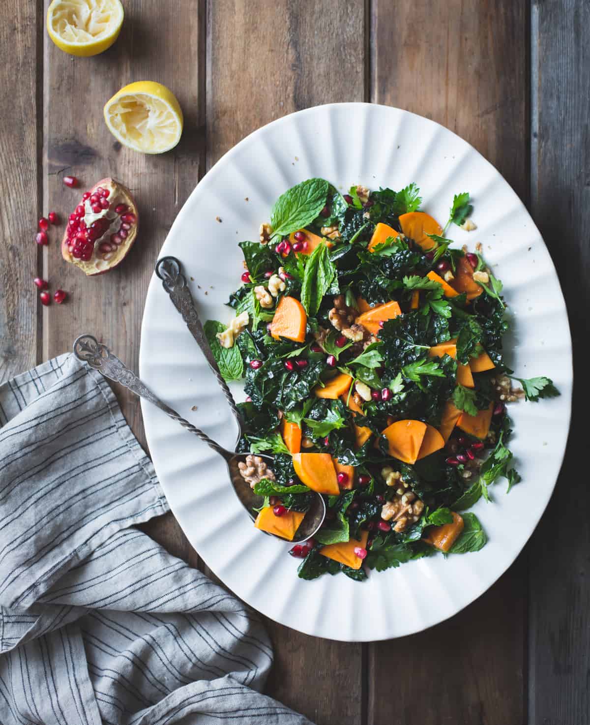big dish of Herbed Kale Salad with Persimmon, Pomegranate and Maple-Cumin Dressing