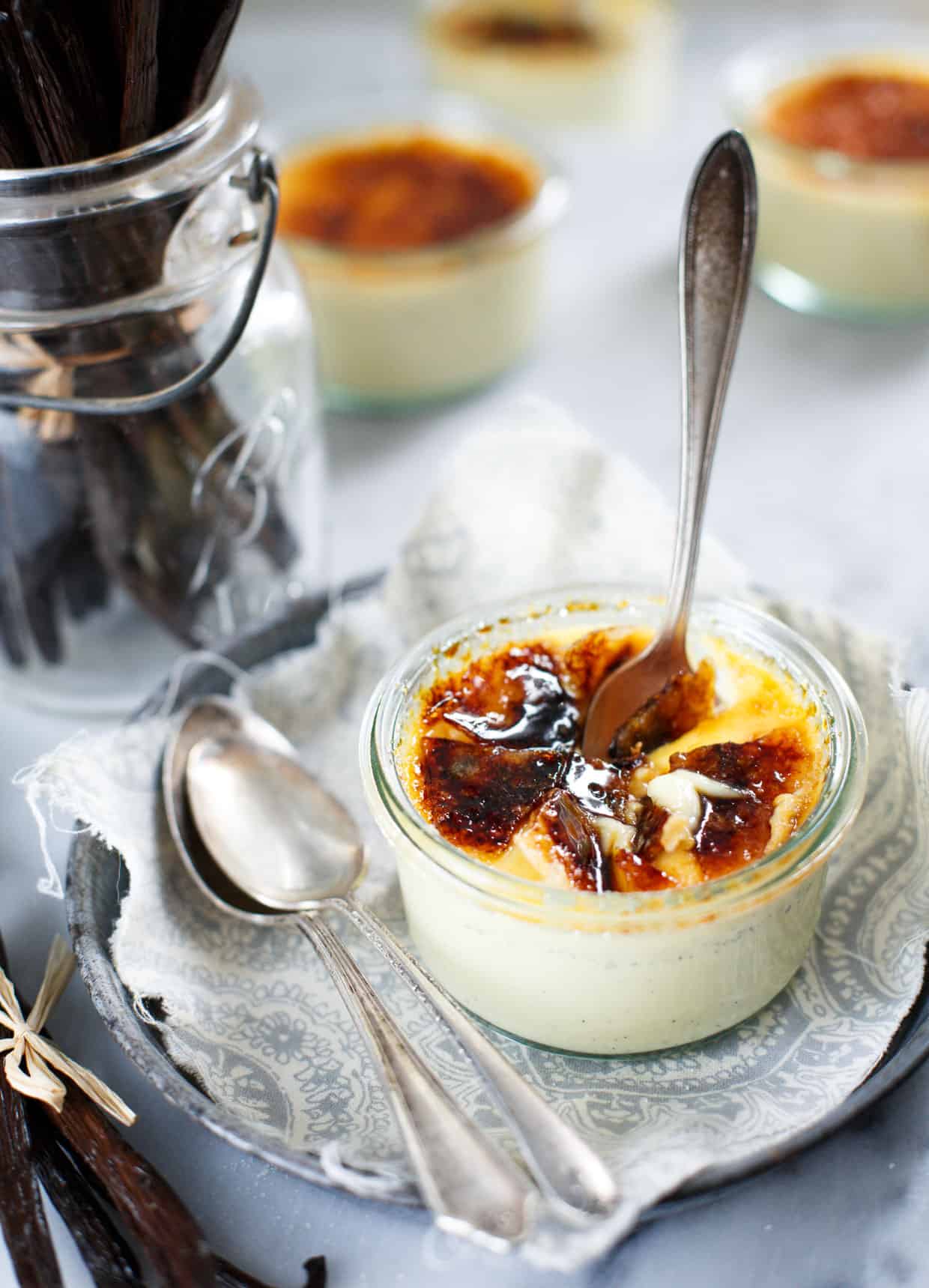 spoon in pot of Vanilla Bean Crème Brûlée