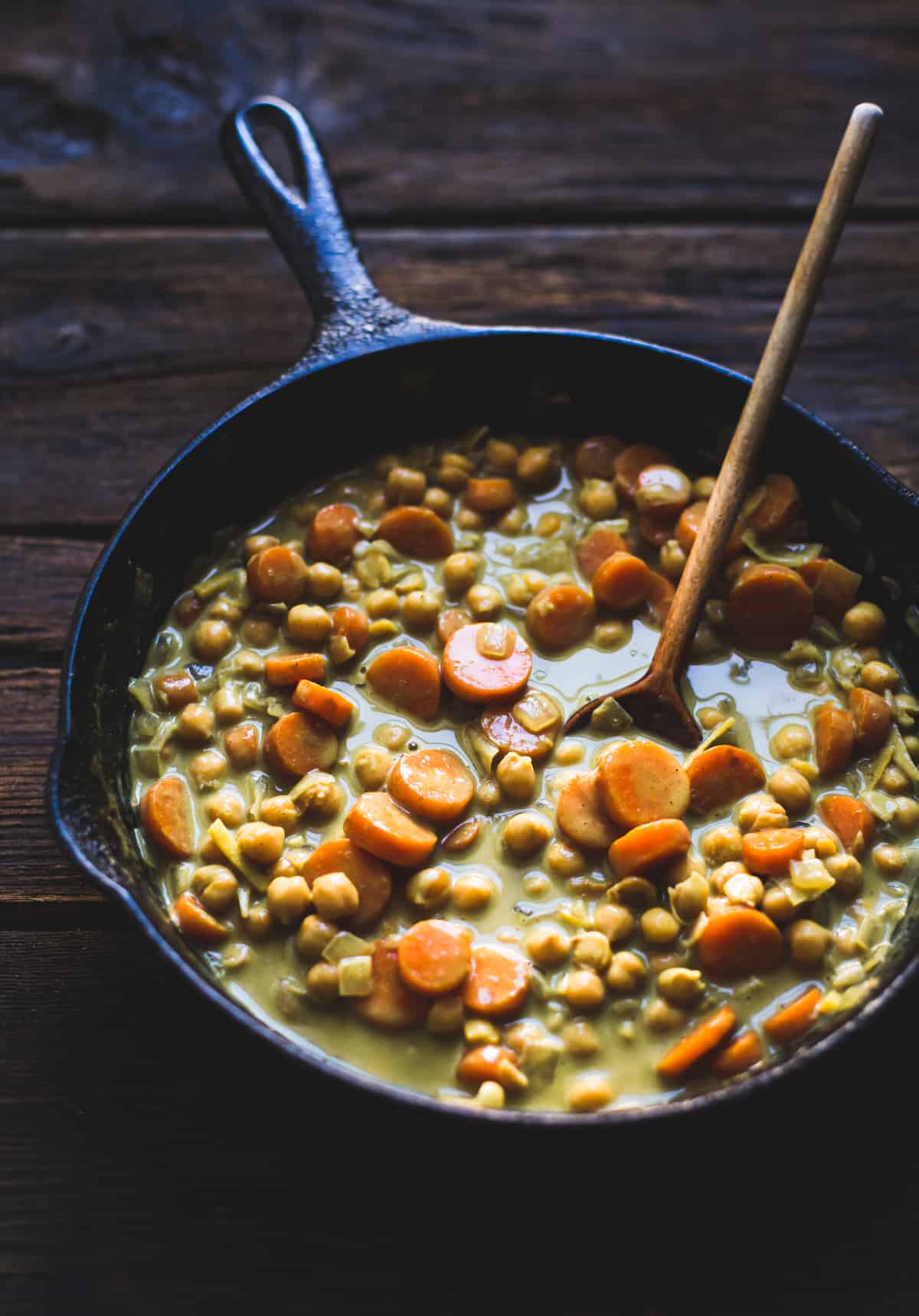 stirring Coconut Curried Chickpeas with Carrots & Cashews {gluten-free, vegan} in skillet 