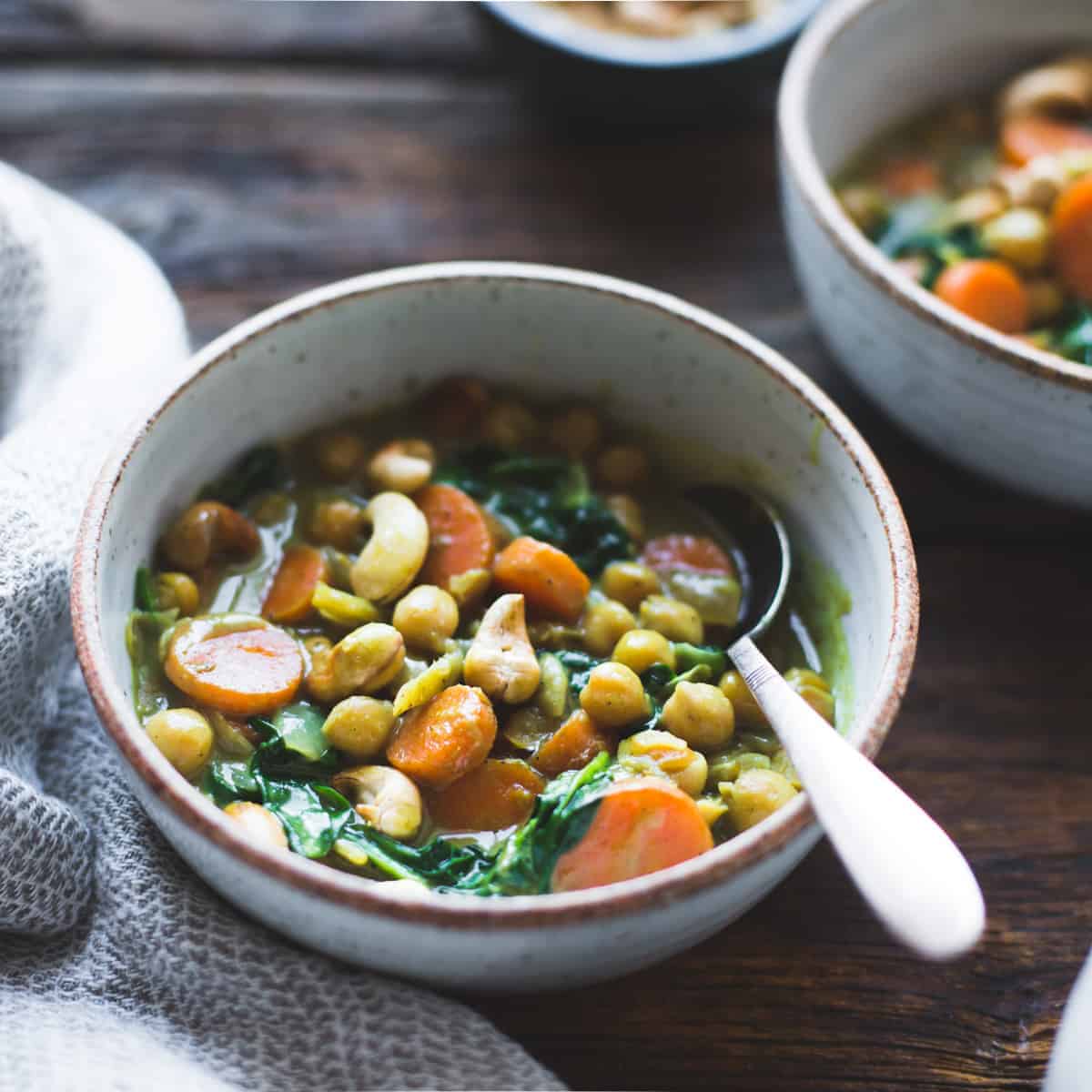 side shot of bowl of Coconut Curried Chickpeas with Carrots & Cashews {gluten-free, vegan}