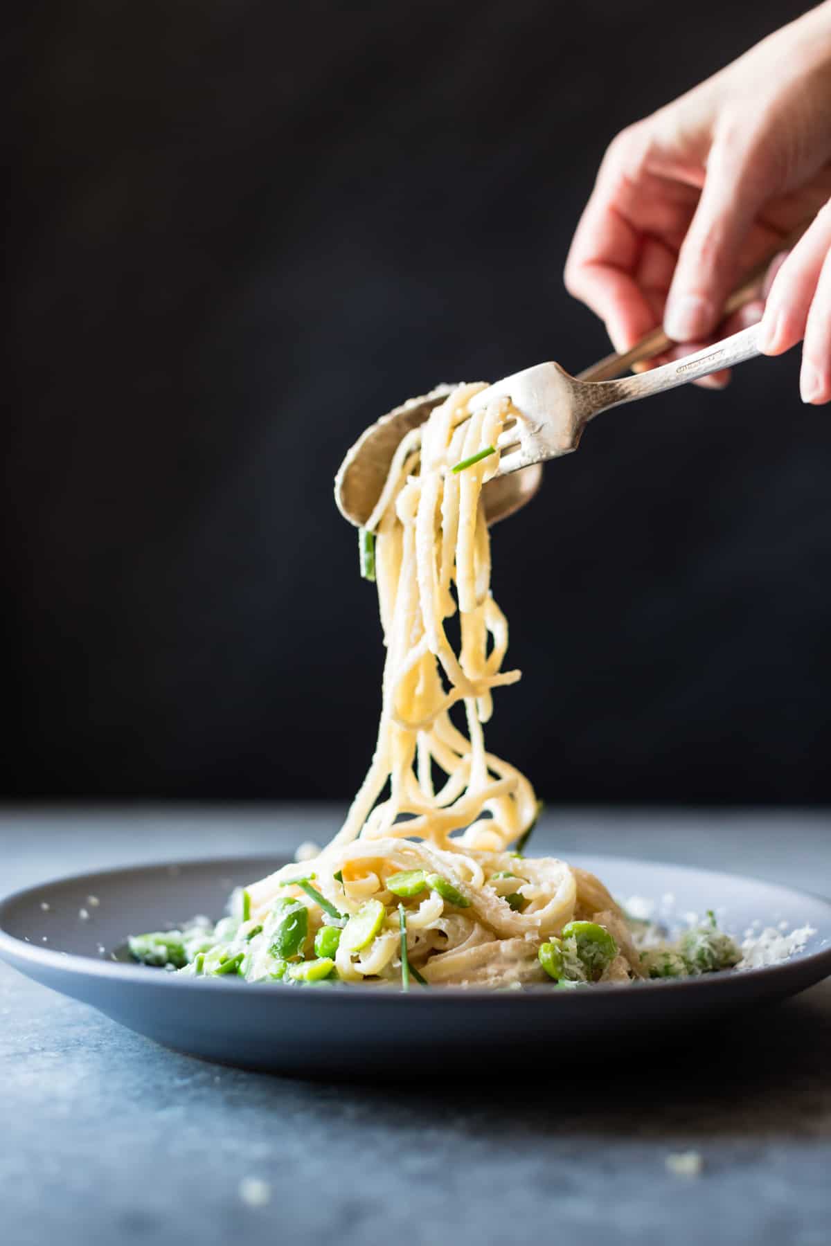 forkful of Creamy Cashew-Miso Pasta with Peas and Fava Beans {gluten-free, vegan option}