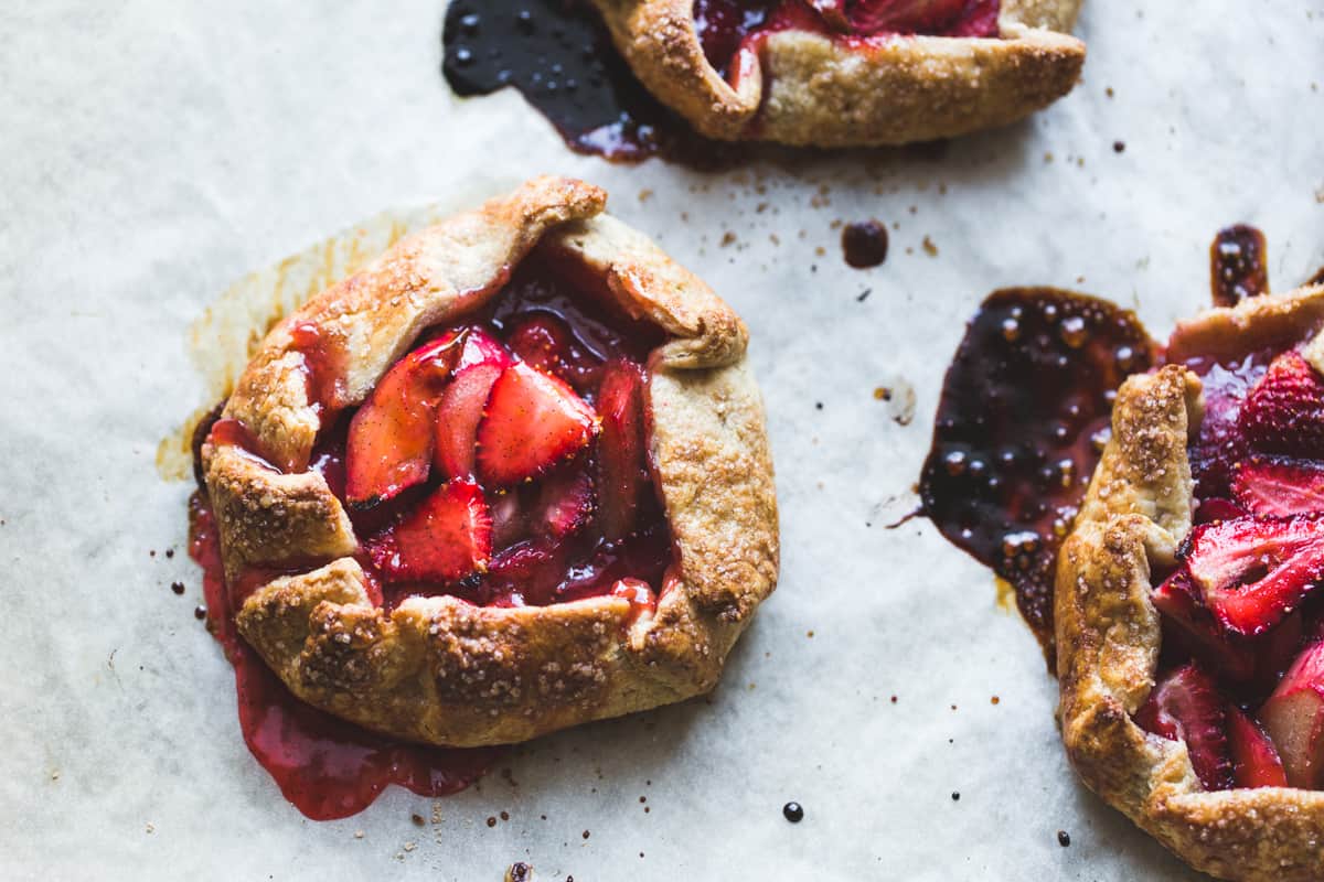 Strawberry Rhubarb Rose Galettes {gluten-free} on parchment