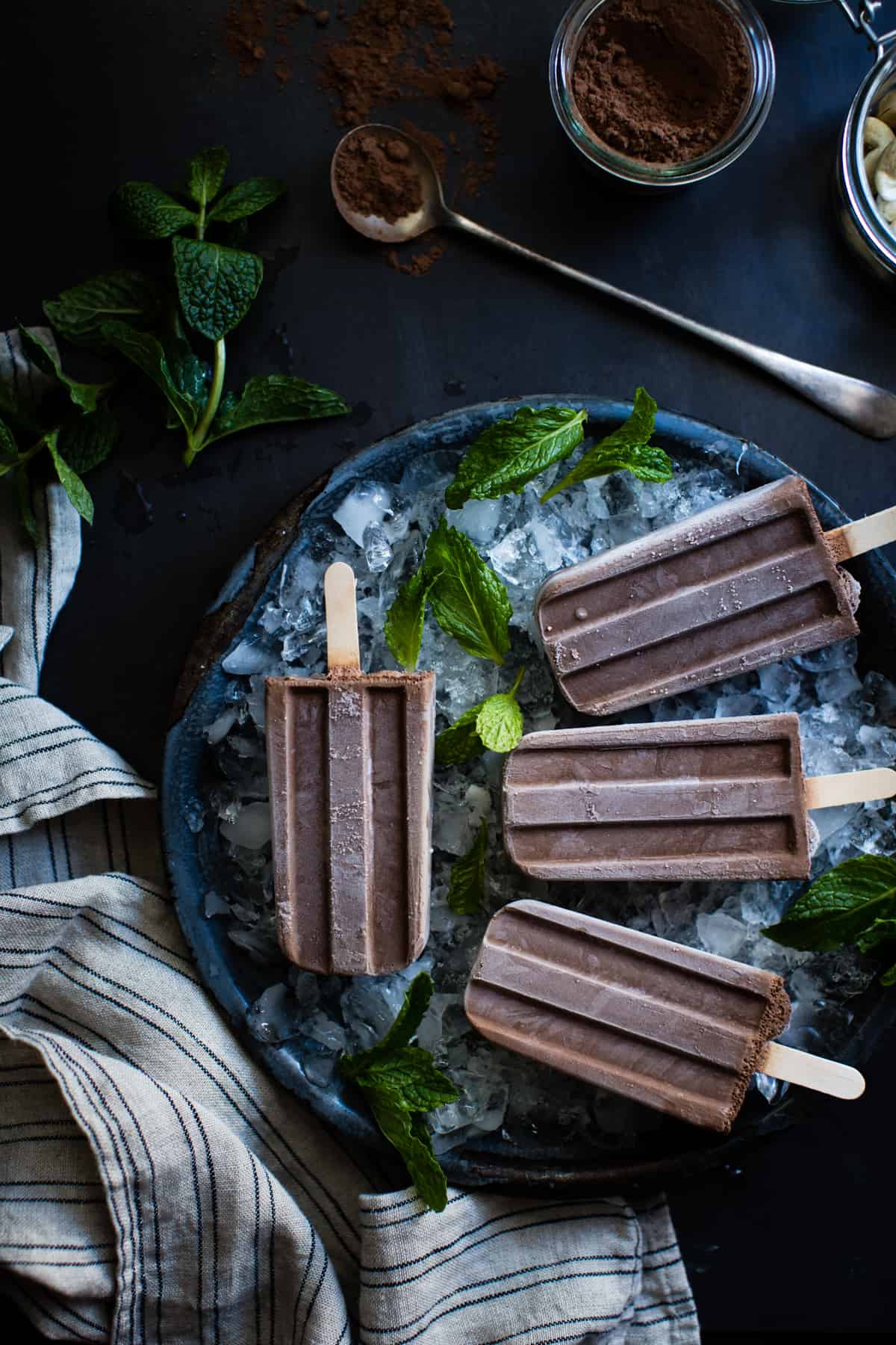 Creamy Vegan Mint Chocolate Popsicles on table 