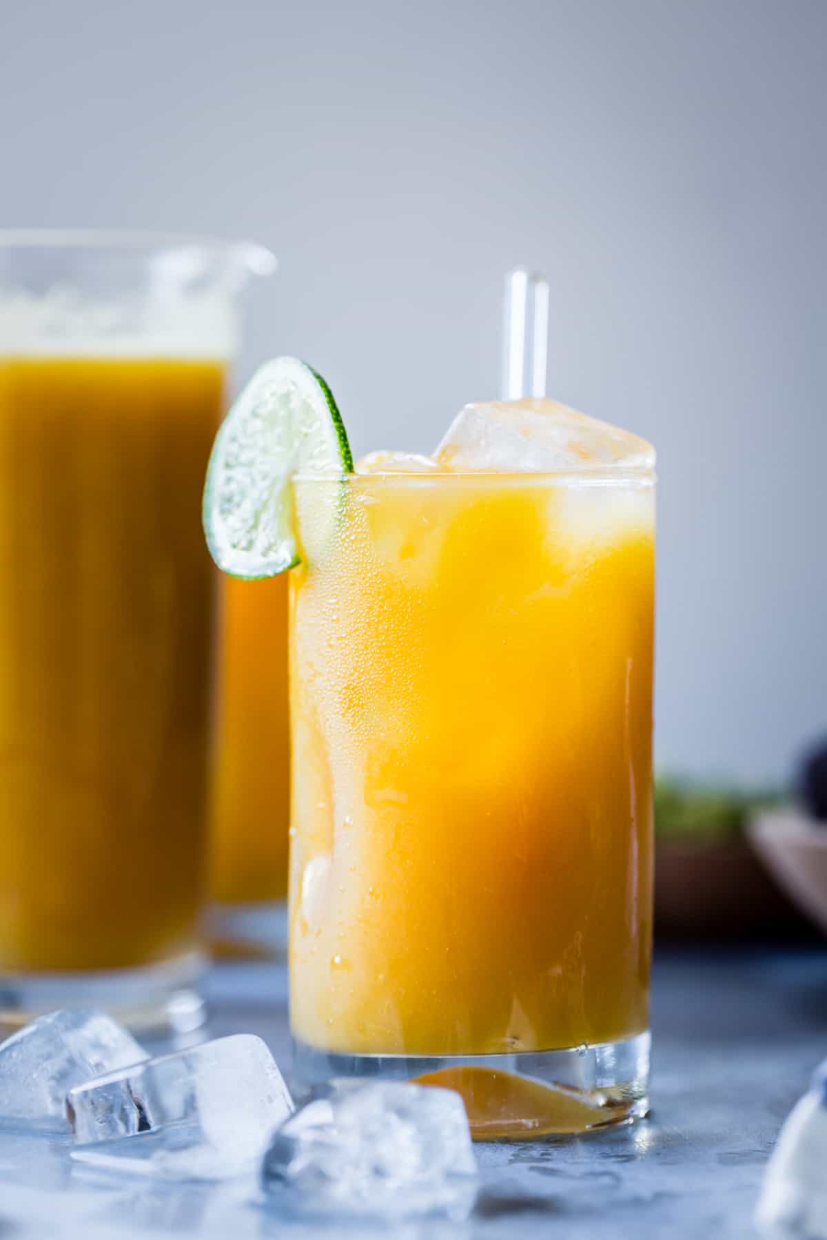 tall glass of Mango Coco Agua Fresca with Ginger and Rum
