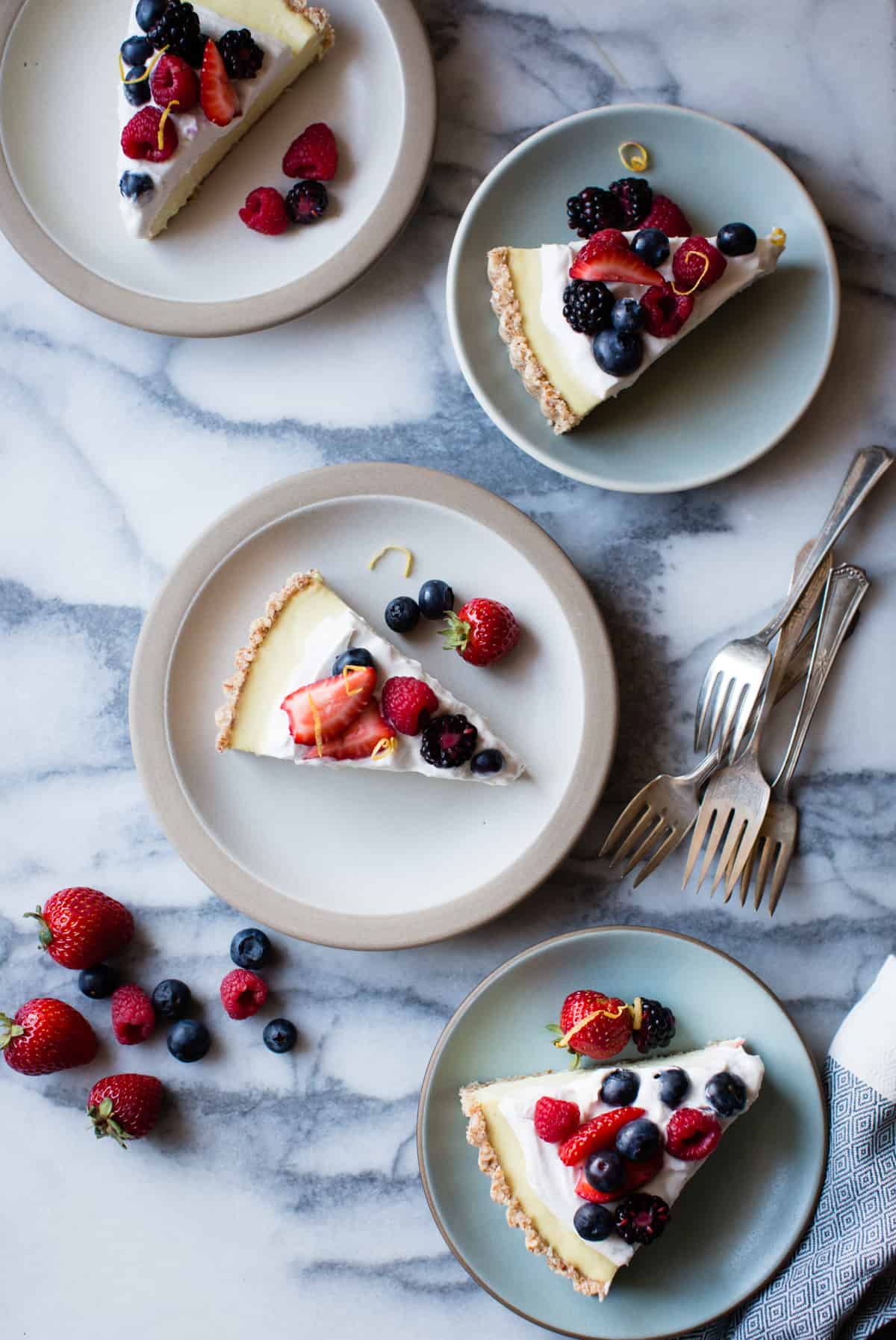 4 plates of No-Bake Lemon Berry Coconut Cream Tart {vegan, gluten-free, refined sugar-free}