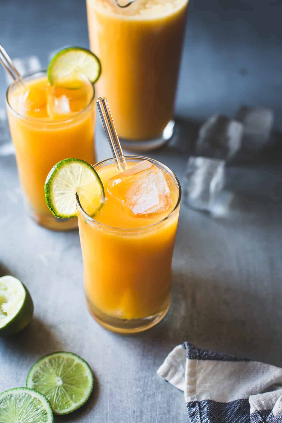 Mango Coco Agua Fresca with Ginger and Rum with slice of lime