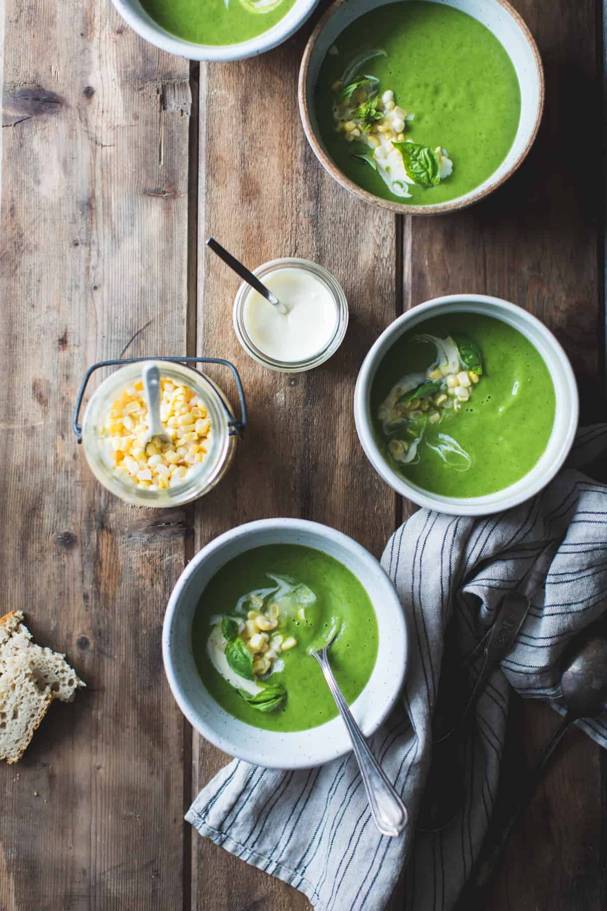 3 bowls of Zucchini Basil Soup with Crème Fraîche and Pickled Corn