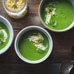 bowls of Zucchini Basil Soup with Crème Fraîche and Pickled Corn