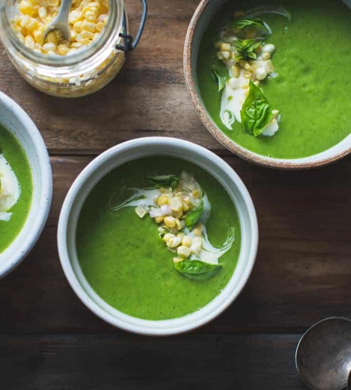 bowls of Zucchini Basil Soup with Crème Fraîche and Pickled Corn
