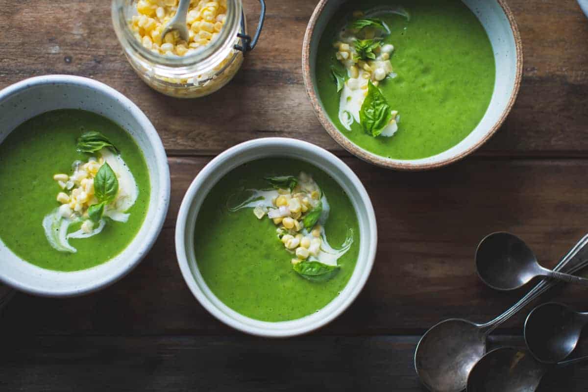 3 bowls of Zucchini Basil Soup with Crème Fraîche and Pickled Corn