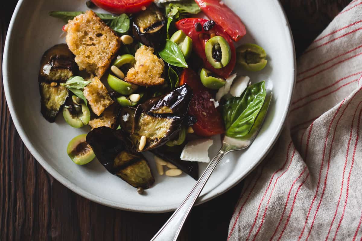 Roasted Eggplant Panzanella with Capers, Olives, and Pine Nuts on plate 