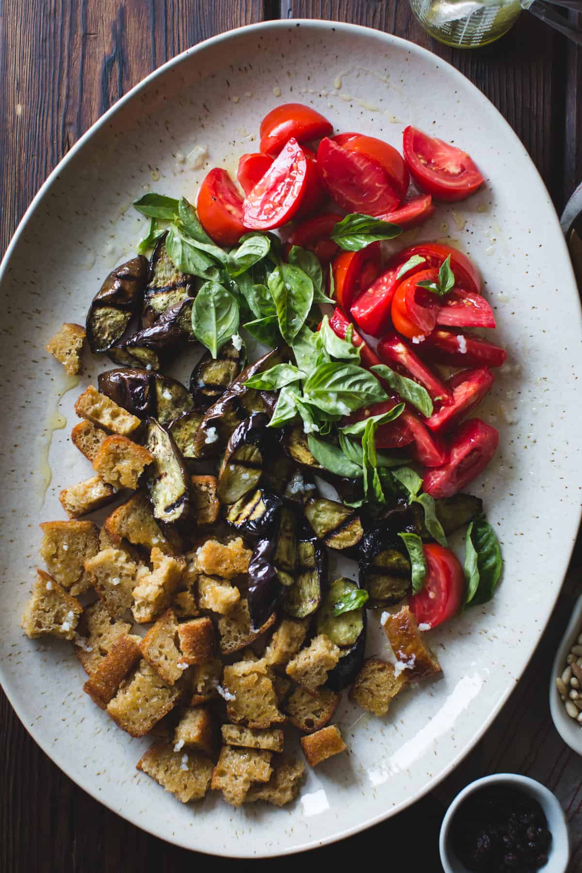 Roasted Eggplant Panzanella with Capers, Olives, and Pine Nuts {gluten-free, vegan option} on dish 