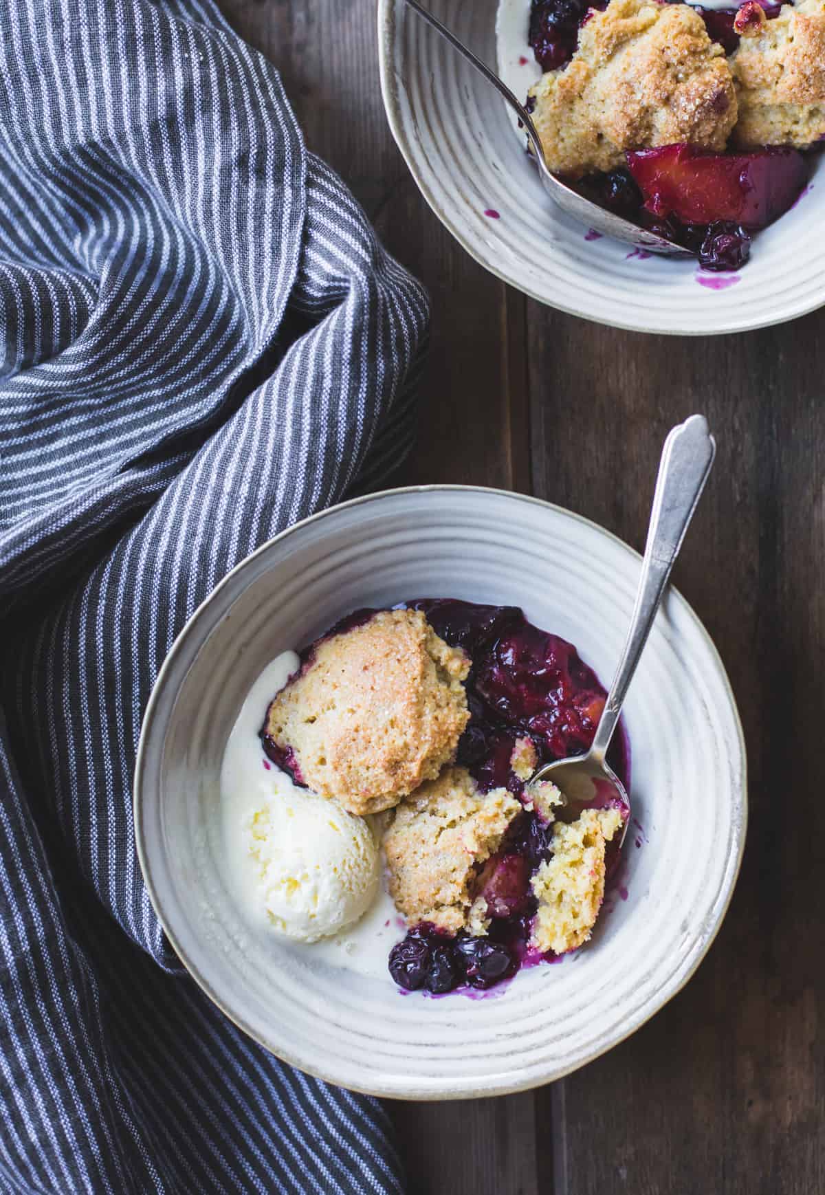 2 bowls of Gluten-Free Blueberry Plum Cobbler with Corn Flour Biscuits