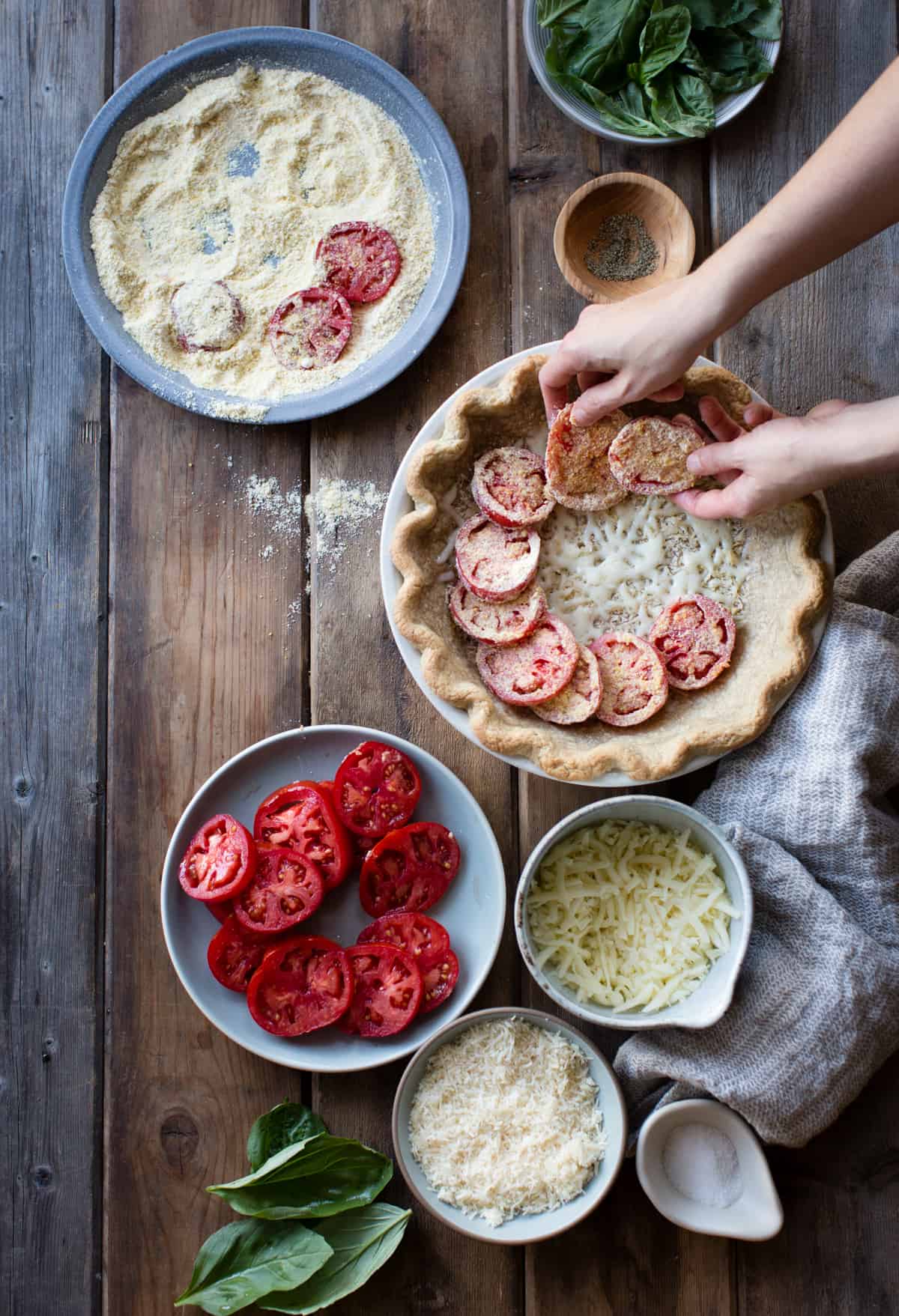 laying tomatoes on pie 