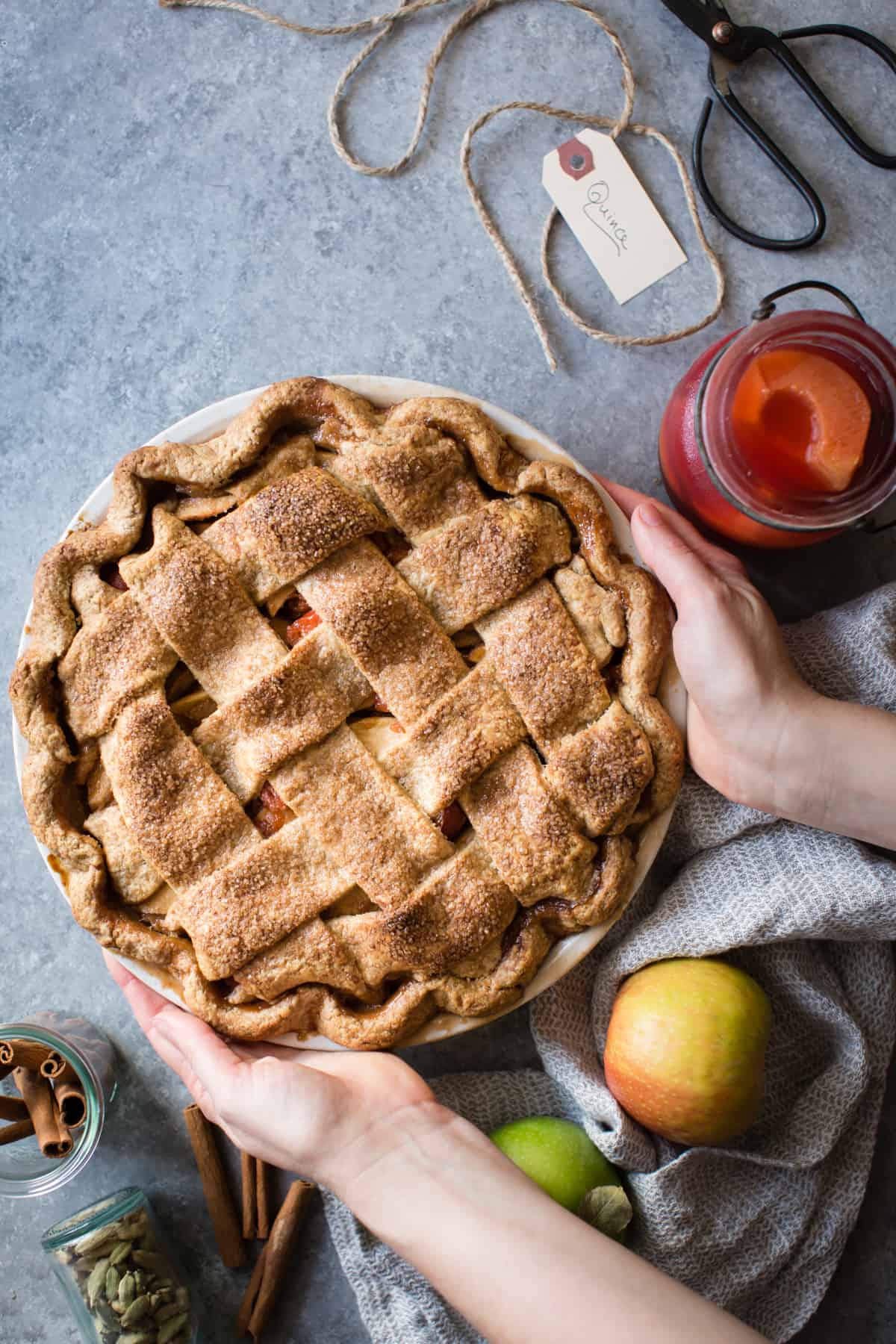 hands holding Gluten Free Apple Pie with Spiced Poached Quince