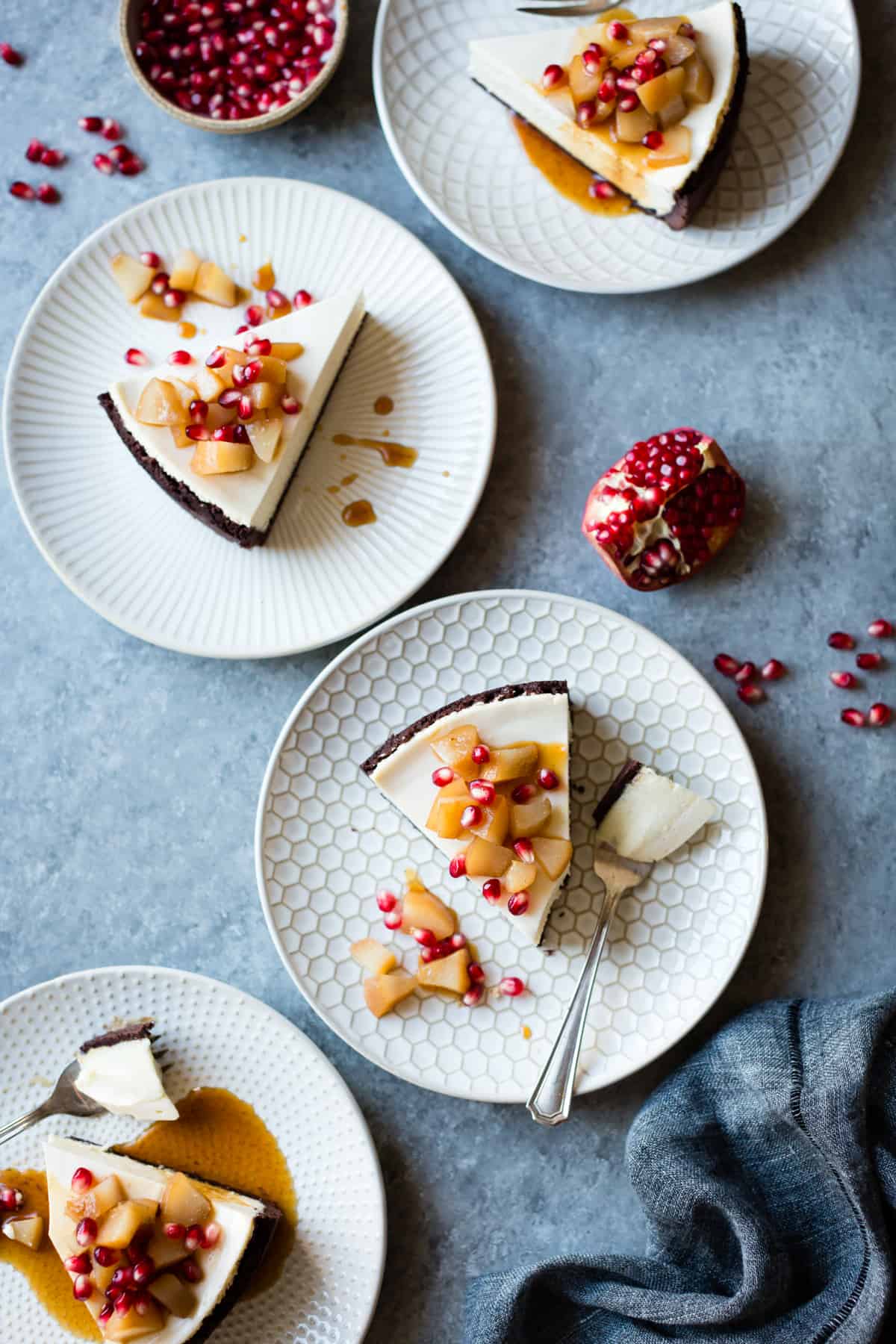 slices of Chocolate Crusted Chèvre Cheesecake with Earl Grey Poached Pears & Pomegranate {gluten-free}