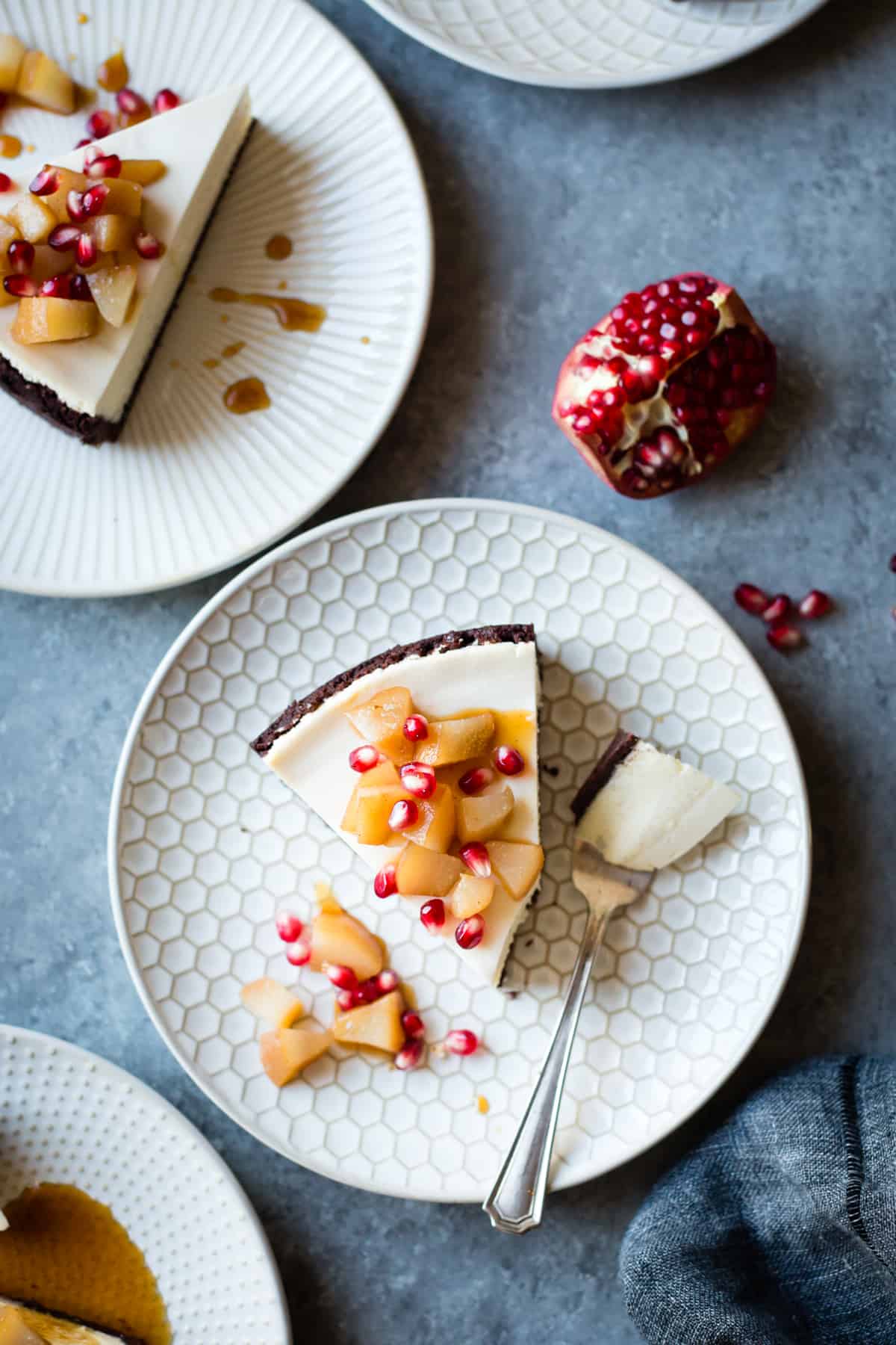 Chocolate Crusted Chèvre Cheesecake with Earl Grey Poached Pears & Pomegranate {gluten-free} on plate 