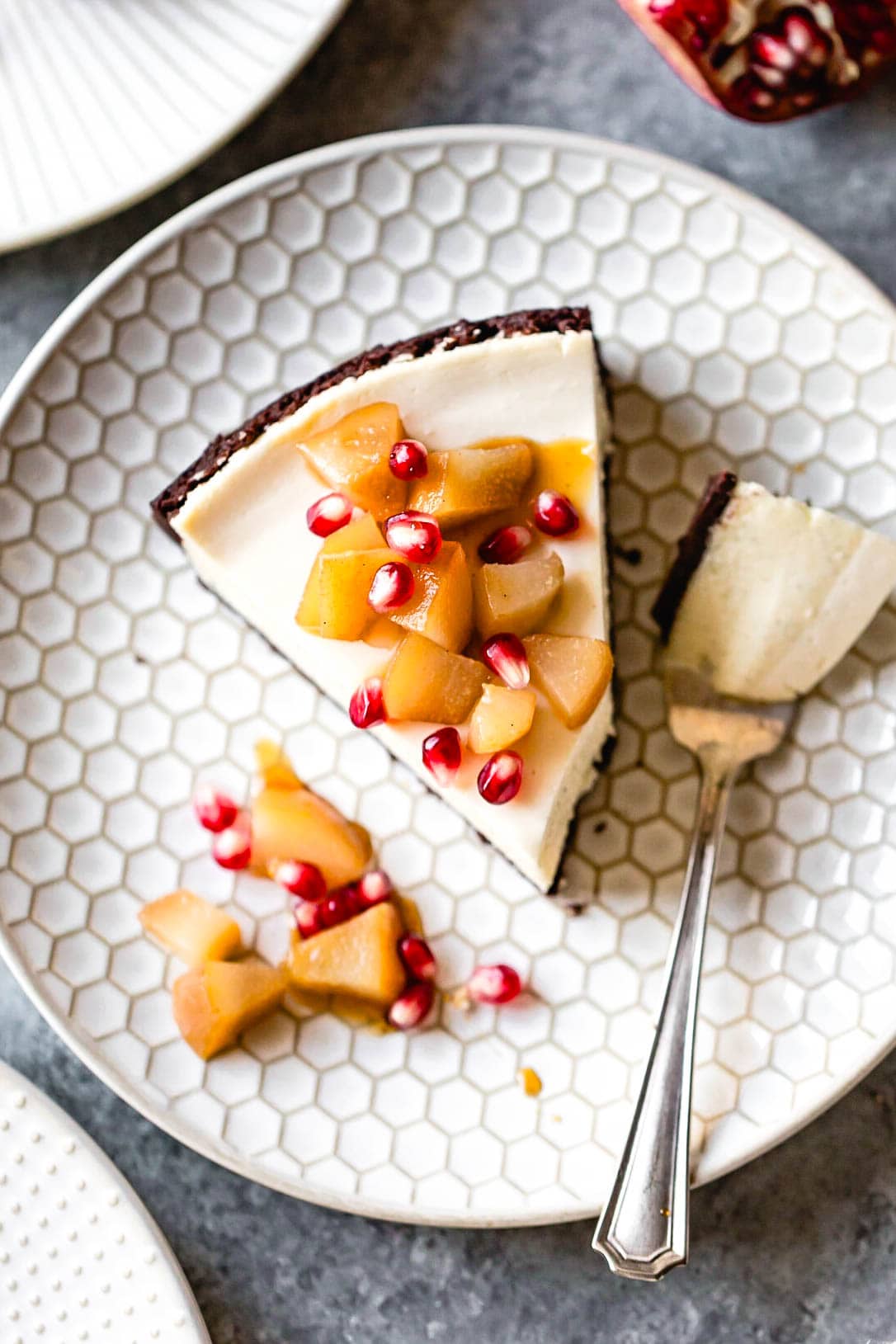 a slice of goat cheese cheesecake is on a plate with a bite taken out