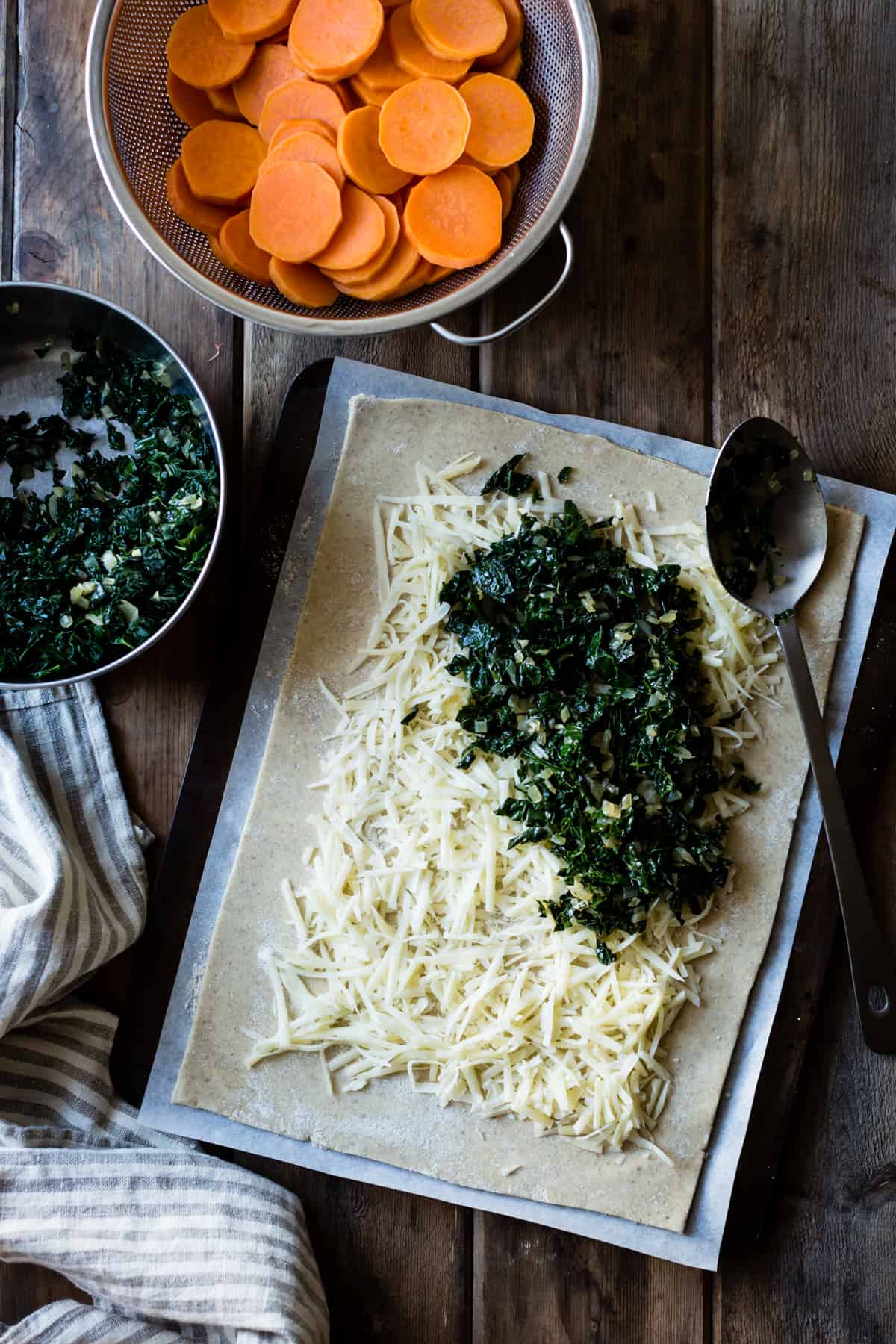 cheese and kale filling have been layered over the gluten-free pie dough 