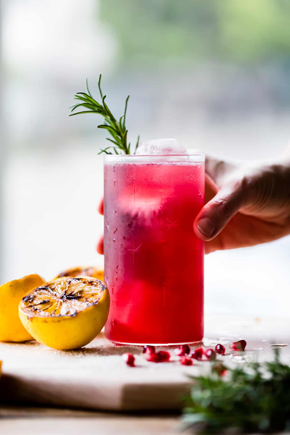tall glass of Rosemary, Pomegranate, & Grilled Meyer Lemon Vodka Sparklers