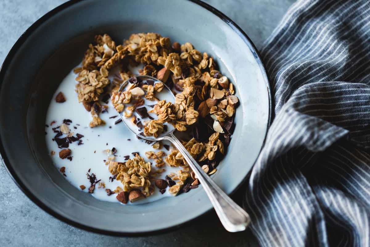 spoon in bowl of Peanut Butter Granola with Cacao Nibs and Bittersweet Chocolate {gluten-free, vegan}