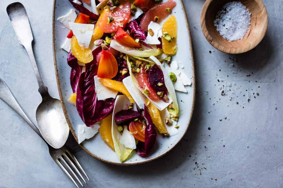 Beet, Citrus, & Chicory Salad with Ricotta Salata and Pistachios and bowl of salt 