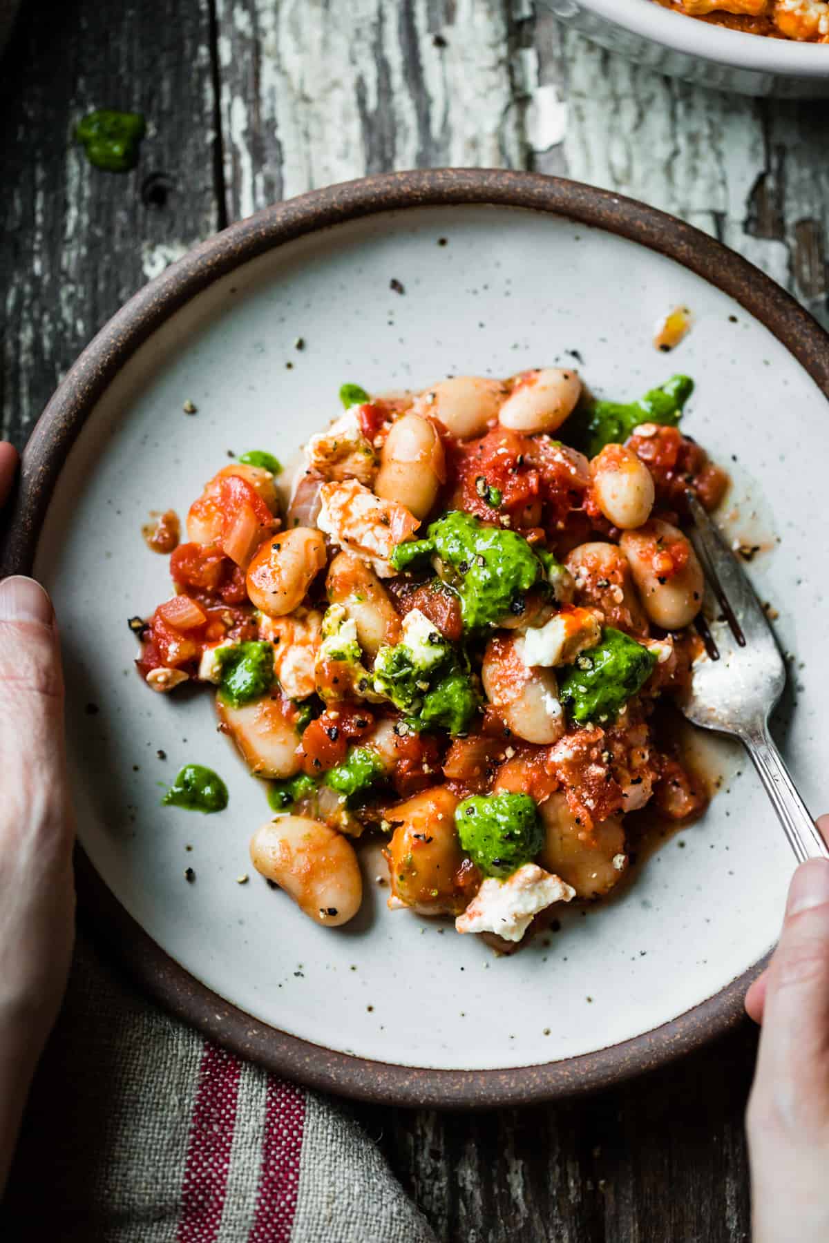 plate of Tomato Baked White Beans with Feta and Lemon Parsley Oil