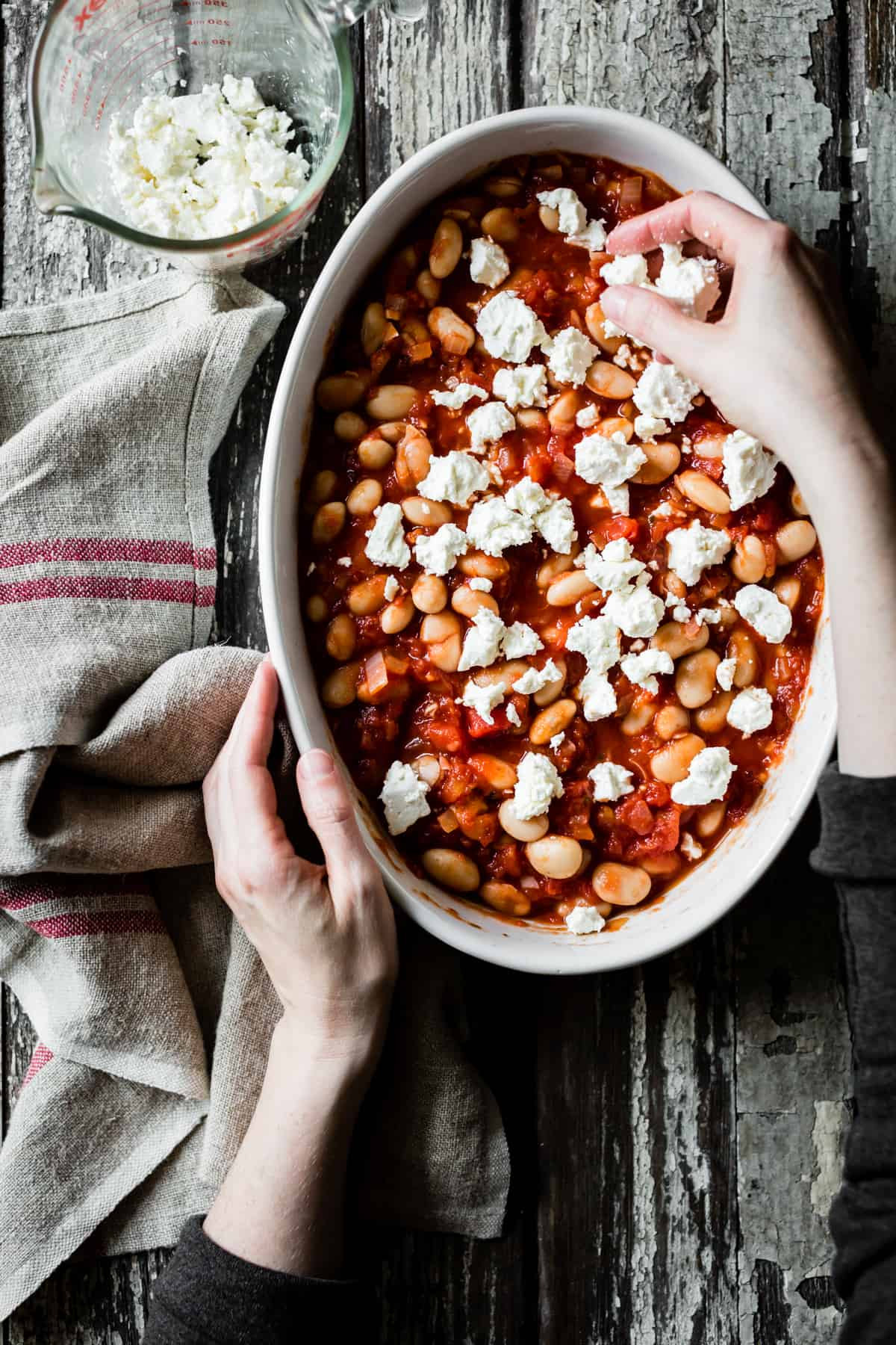 crumbling feta on dish 