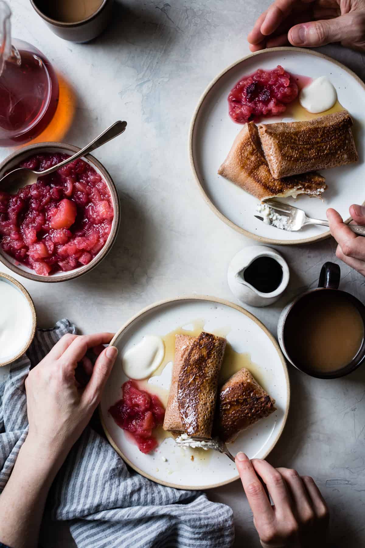 people eating Chestnut Cheese Blintzes with Cranberry Applesauce {gluten-free}