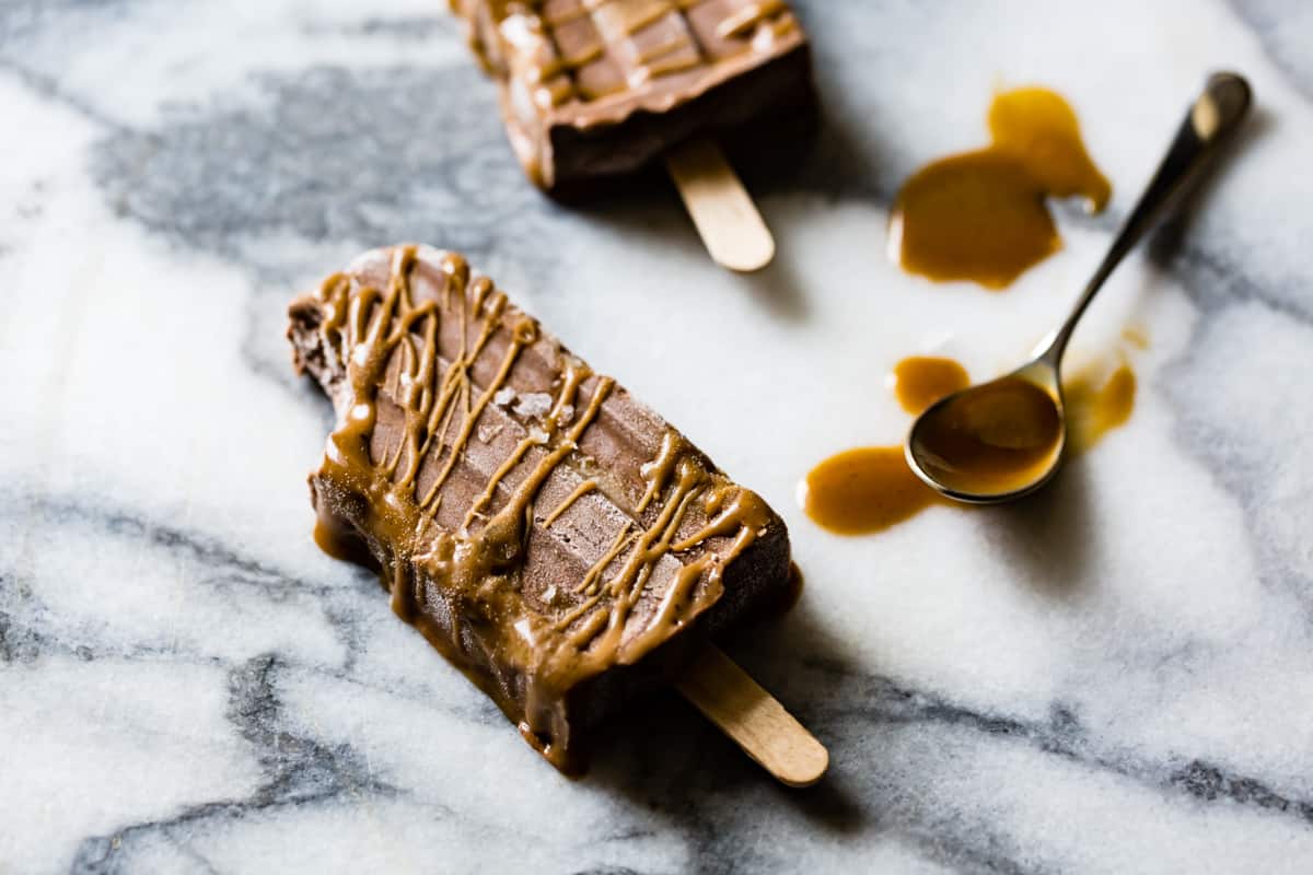 Vegan Salted Caramel & Chocolate Swirl Popsicle with bite taken out 