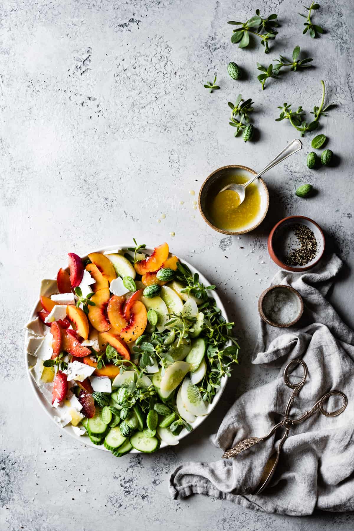 big bowl of Stone Fruit Cucumber Salad with Ricotta Salata, Purslane, and Golden Balsamic Miso Vinaigrette