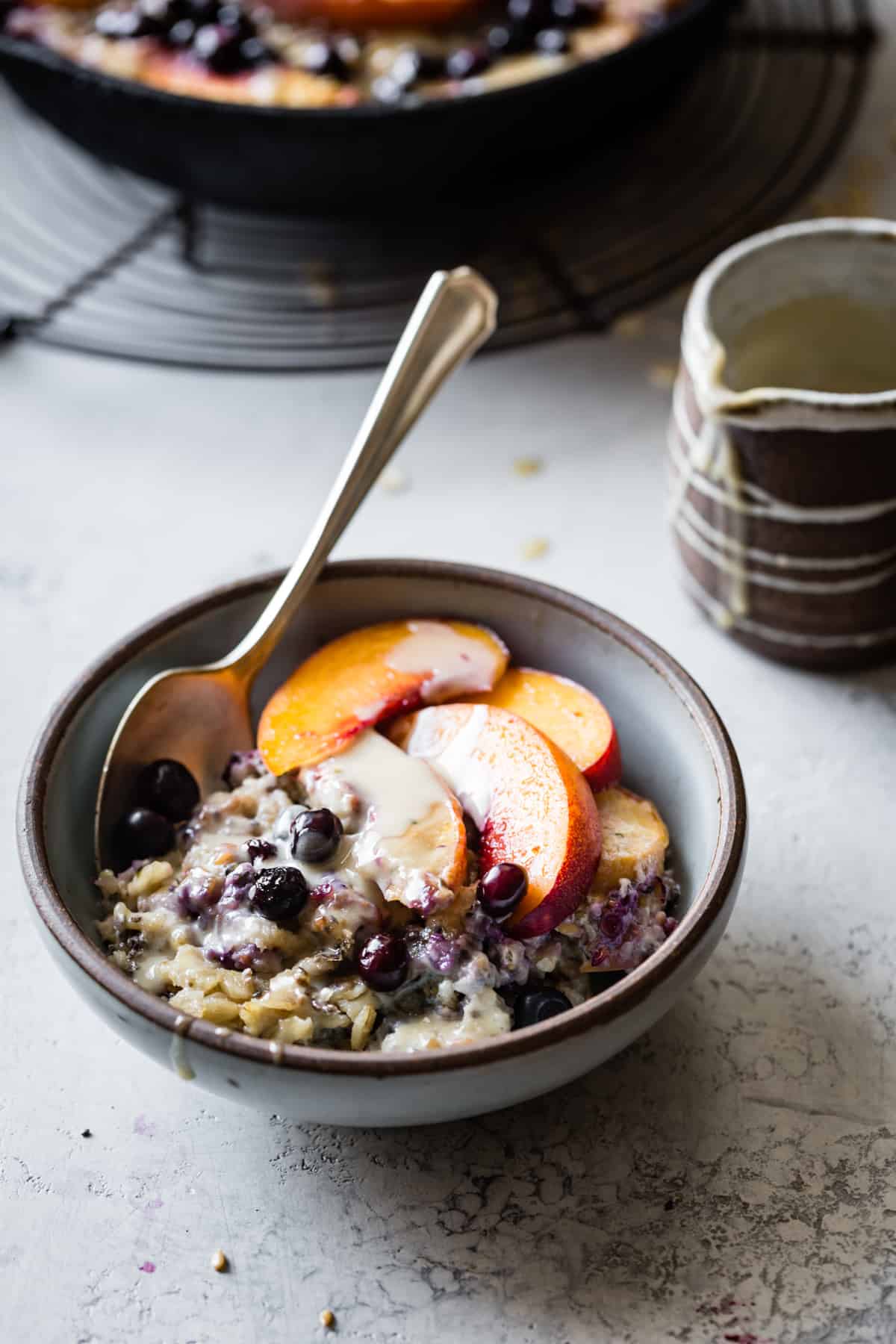 bowl of Super Seedy Vegan Baked Oatmeal with Peaches and Huckleberries {gluten-free & dairy-free}