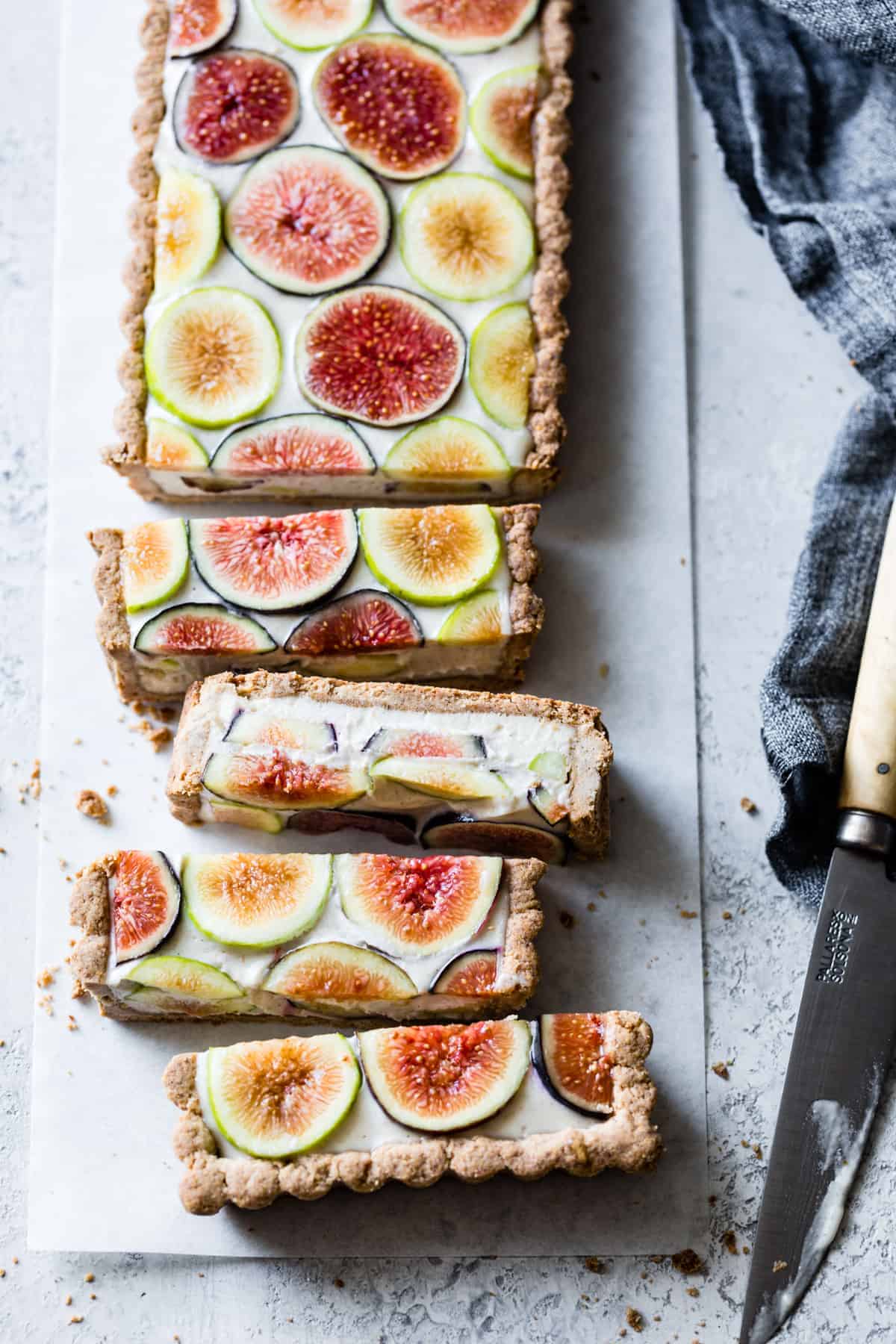 Gluten-free fig tart, sliced, on a gray stone surface