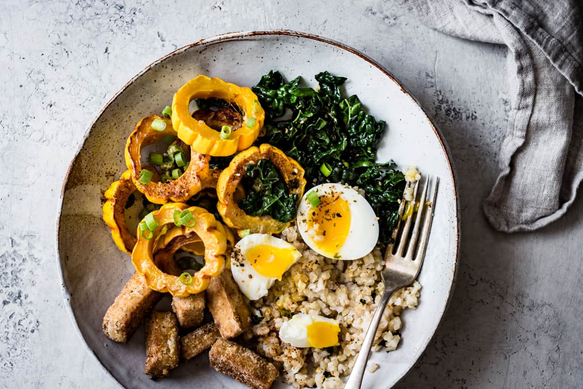 Fall Brown Rice Veggie Bowls with Crispy Tofu, Roasted Squash, and Miso Butter on plate 