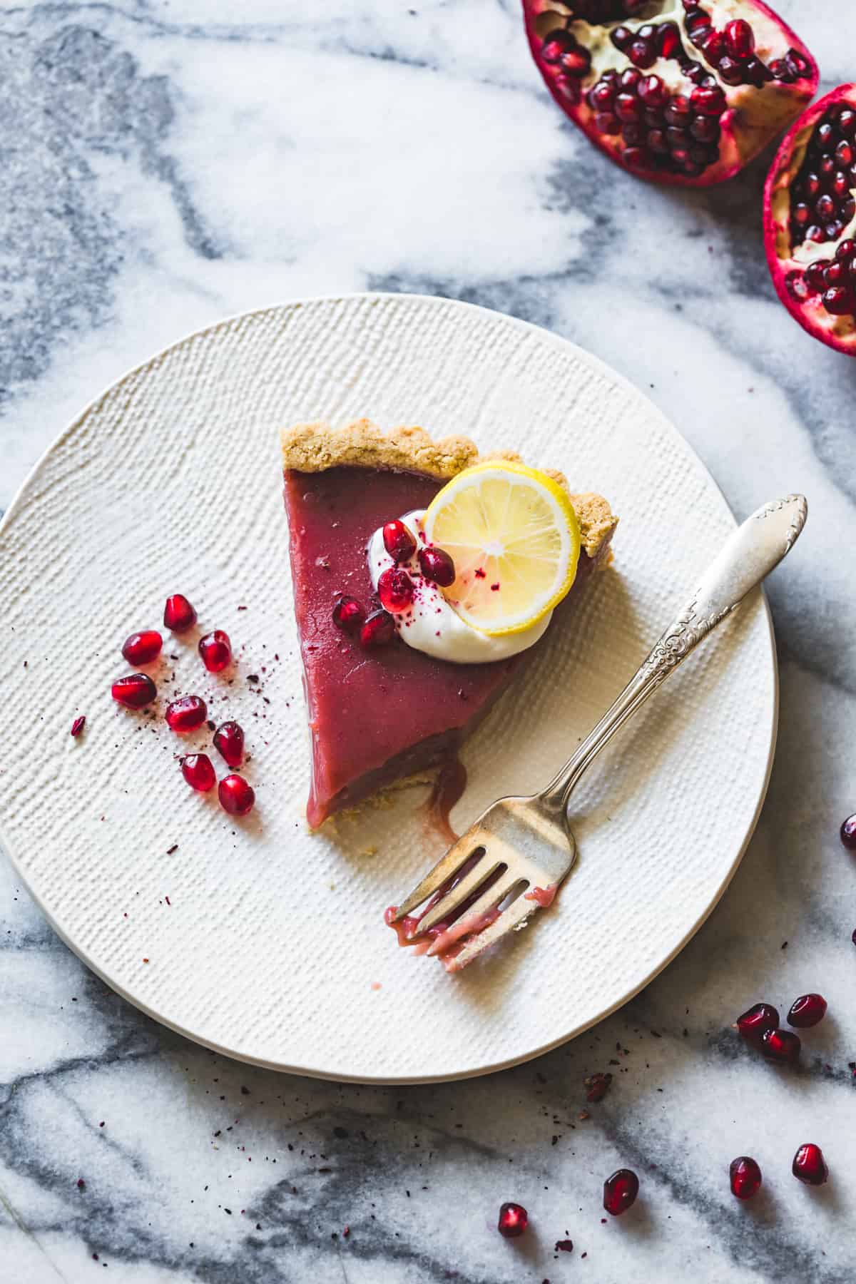 a slice of Pomegranate Tart with Hibiscus, Lemon, and Almond Flour Crust {gluten-free}
