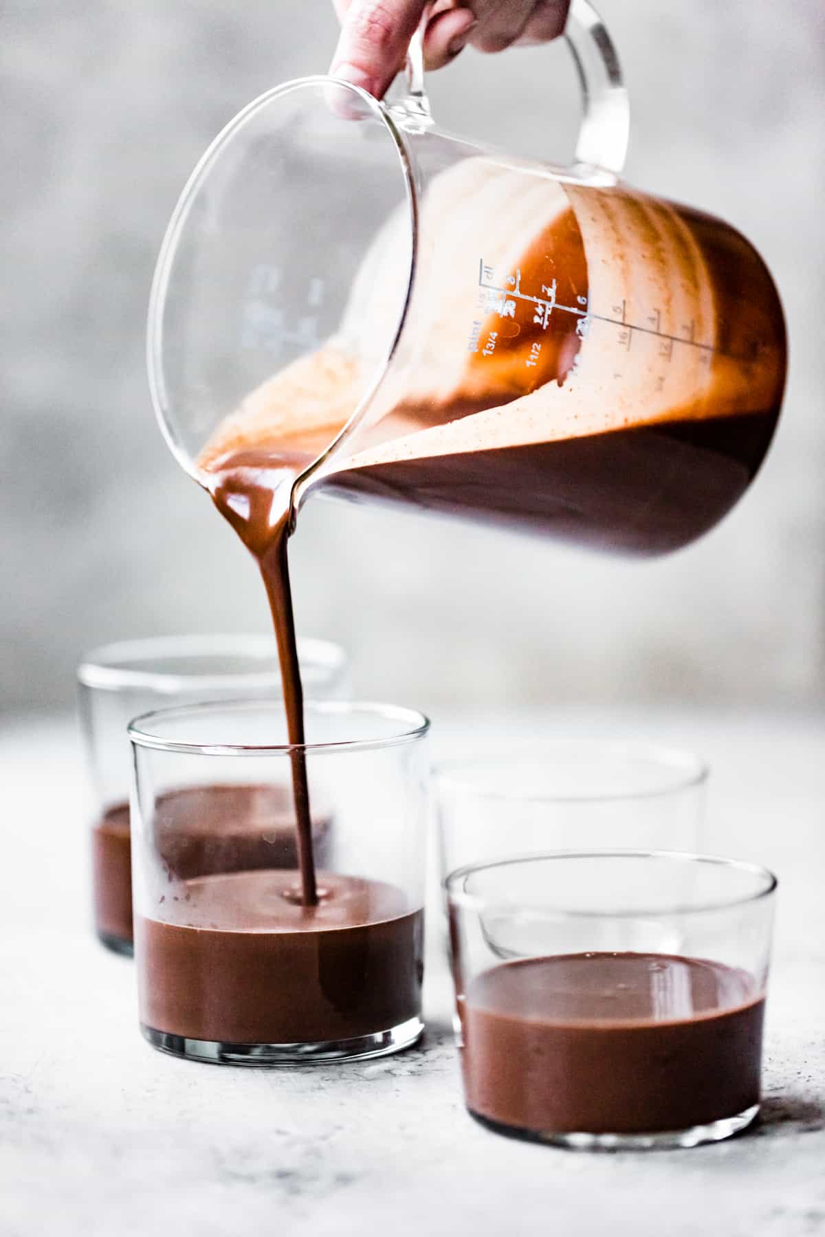 pouring chocolate mix into pots