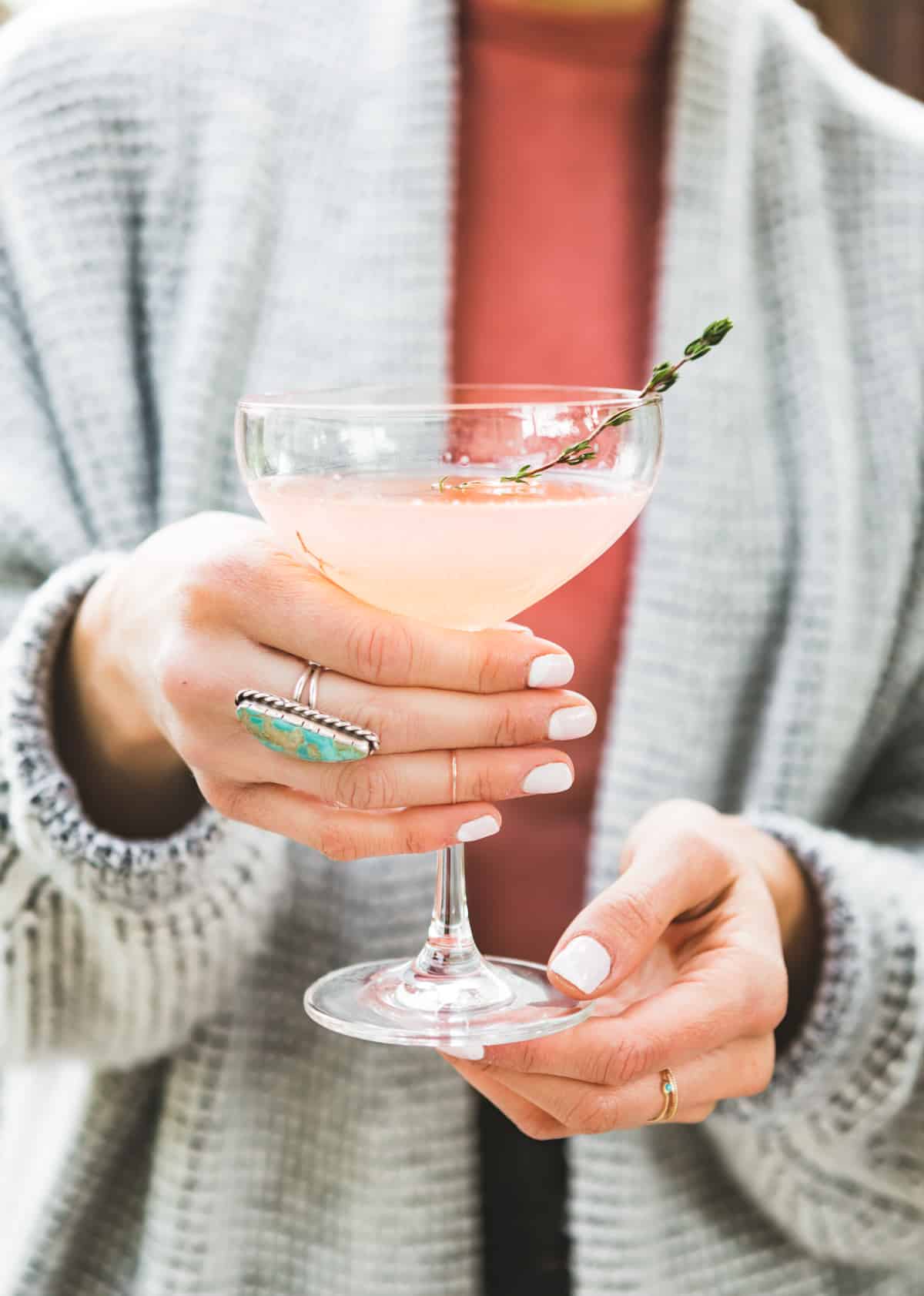 hand holding Sparkling Grapefruit, Elderflower & Rosé Vodka Cocktail