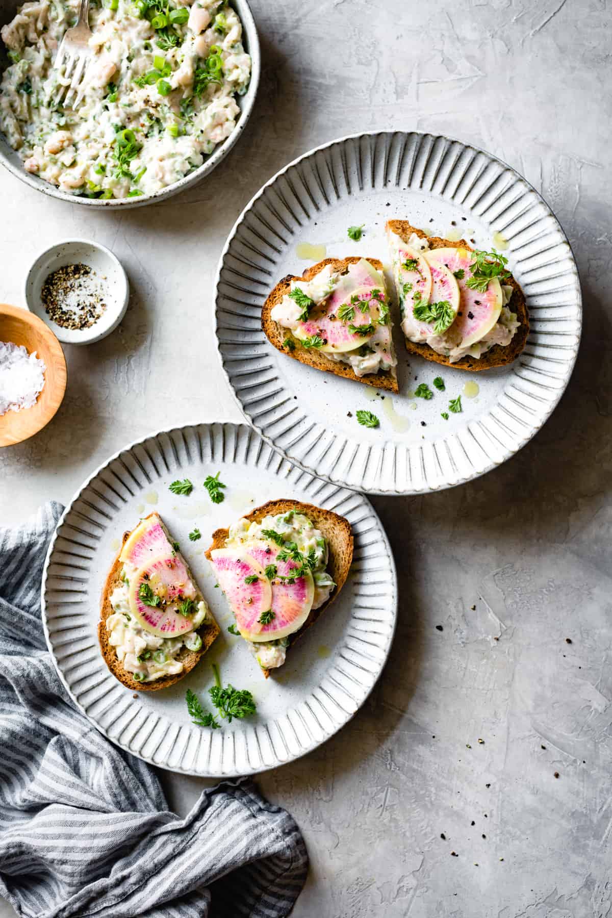 2 plates of Smashed White Bean Salad Tartines with Herbs & Watermelon Radish {gluten-free & vegan options}