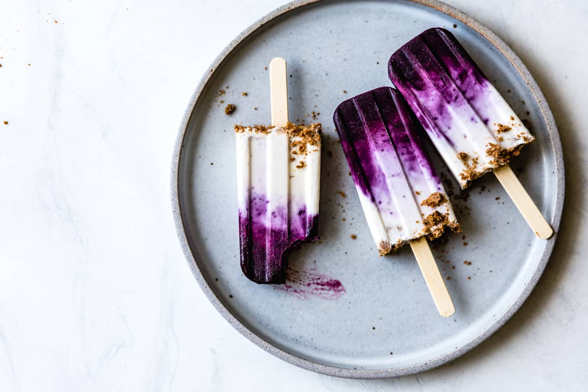 3 Blueberry Chèvre Cheesecake Popsicles on plate 