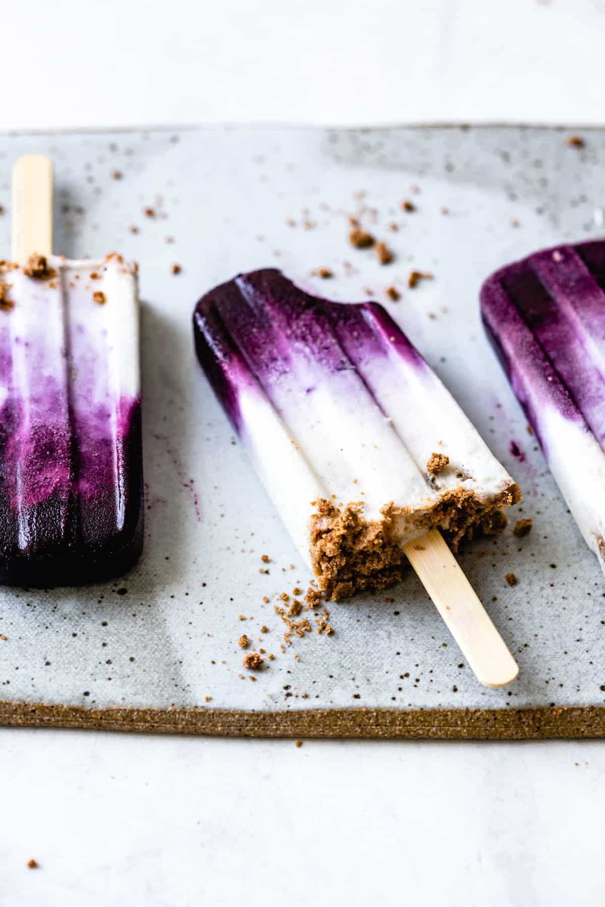 Blueberry Chèvre Cheesecake Popsicles with bite taken out 
