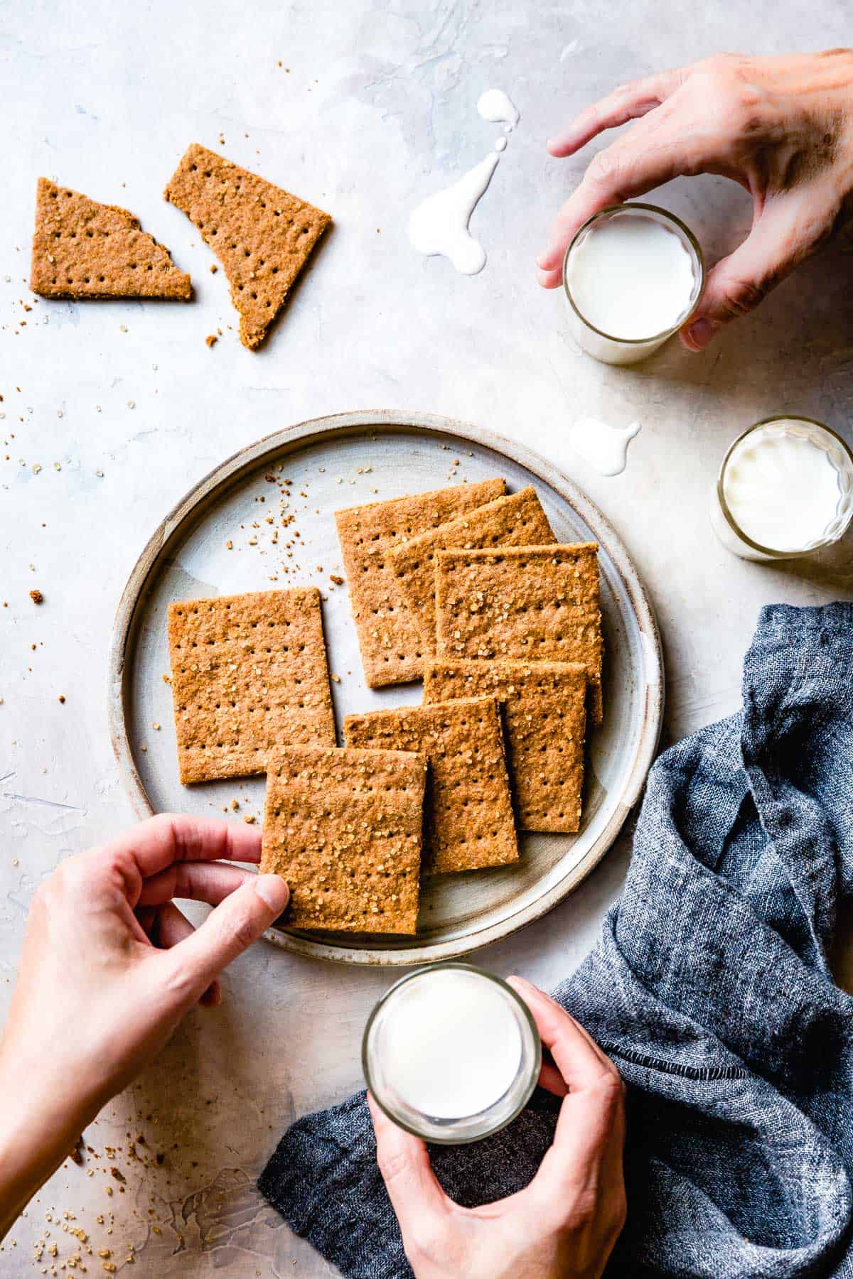 Two people are enjoying a plate of gluten-free graham crackers