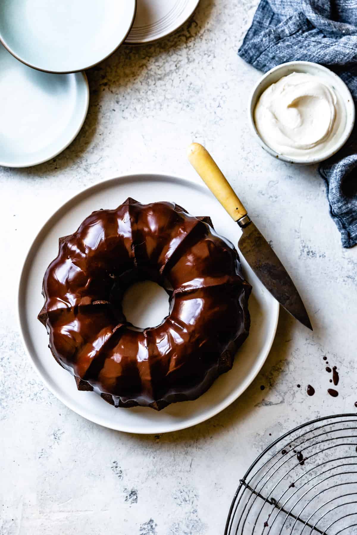 creme fraiche ganache graces the top of a bundt cake forming a glossy topping