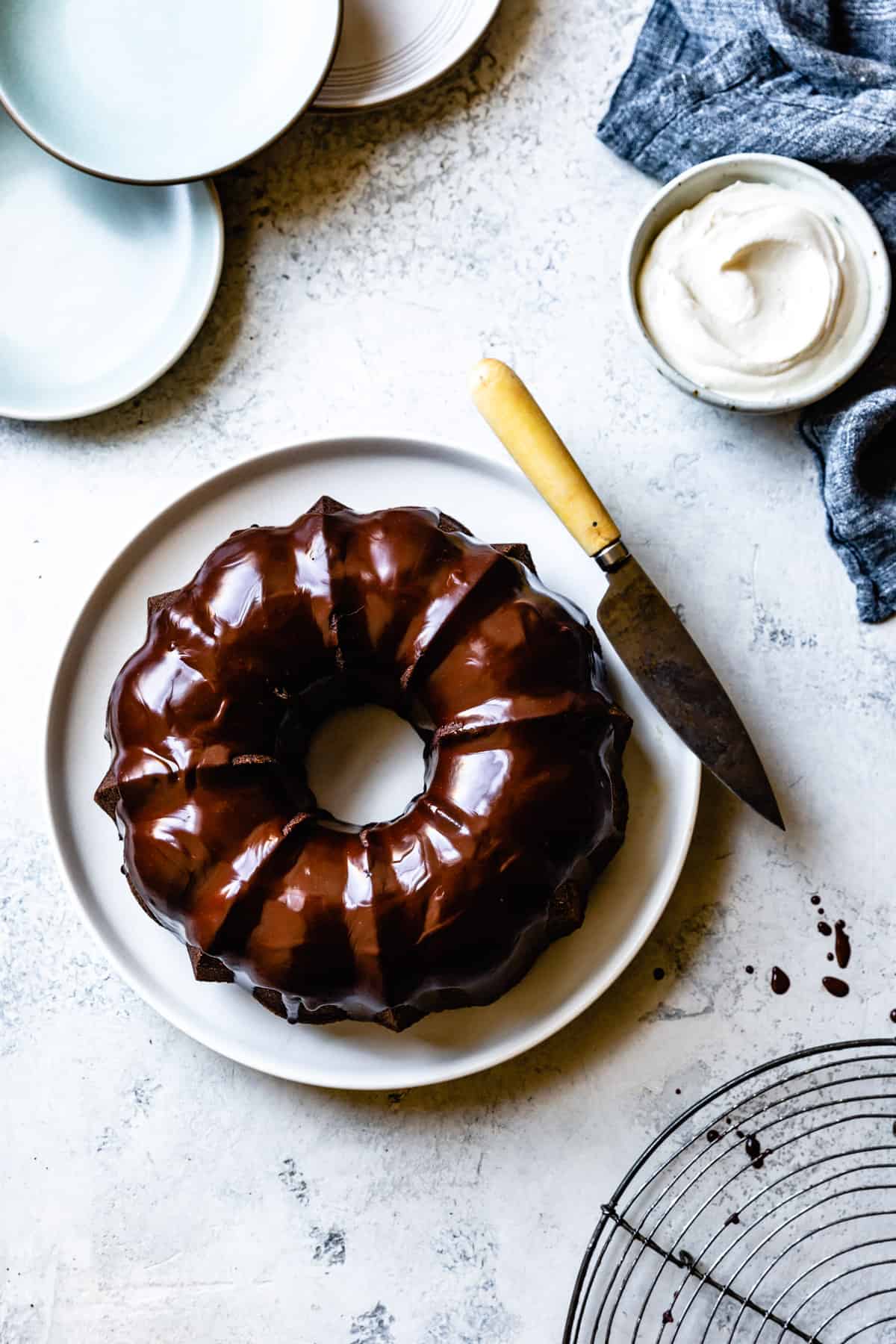 ganache-glazed bundt cake is shown from overhead