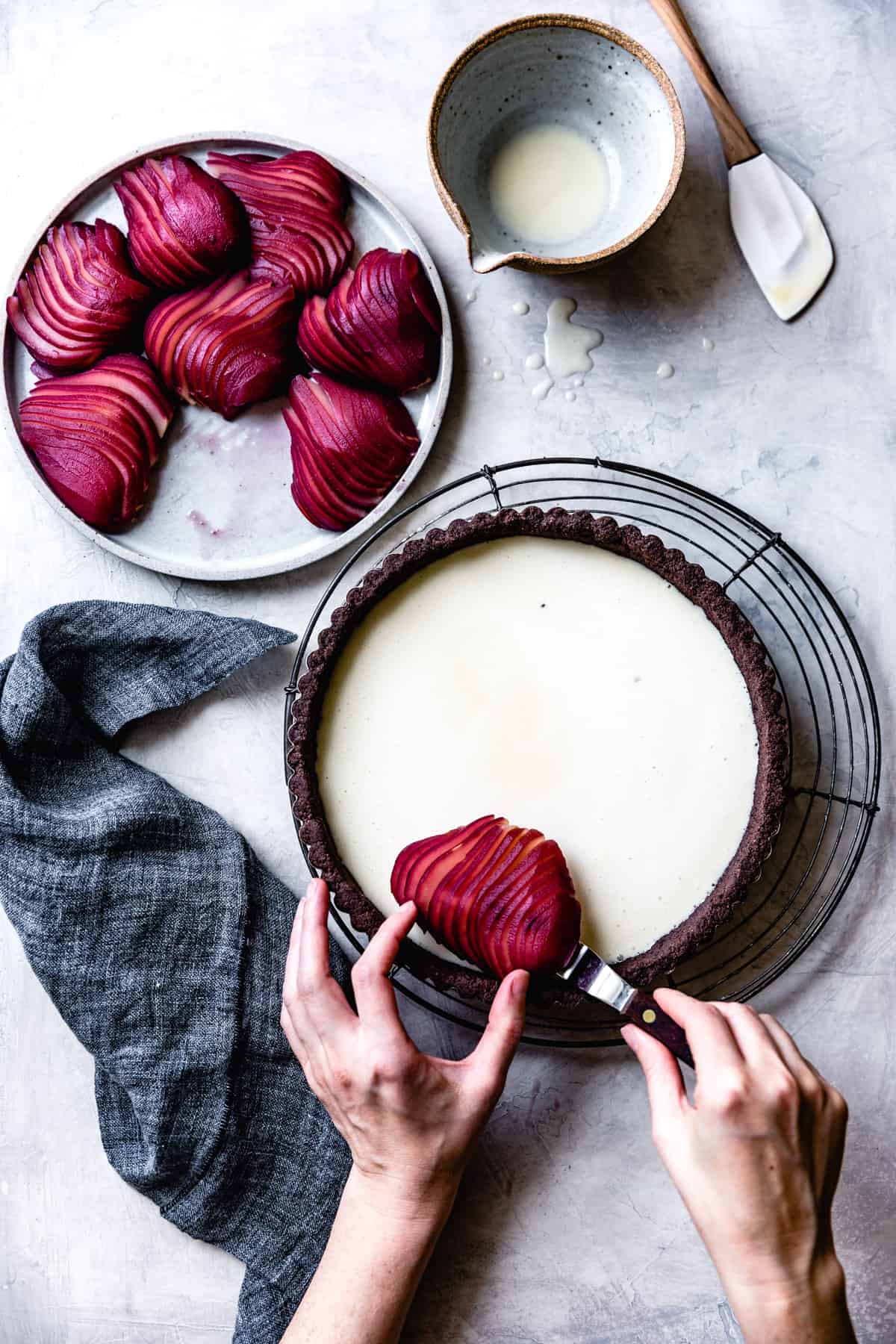 laying poached pears on Gluten-Free Pear Custard Tart