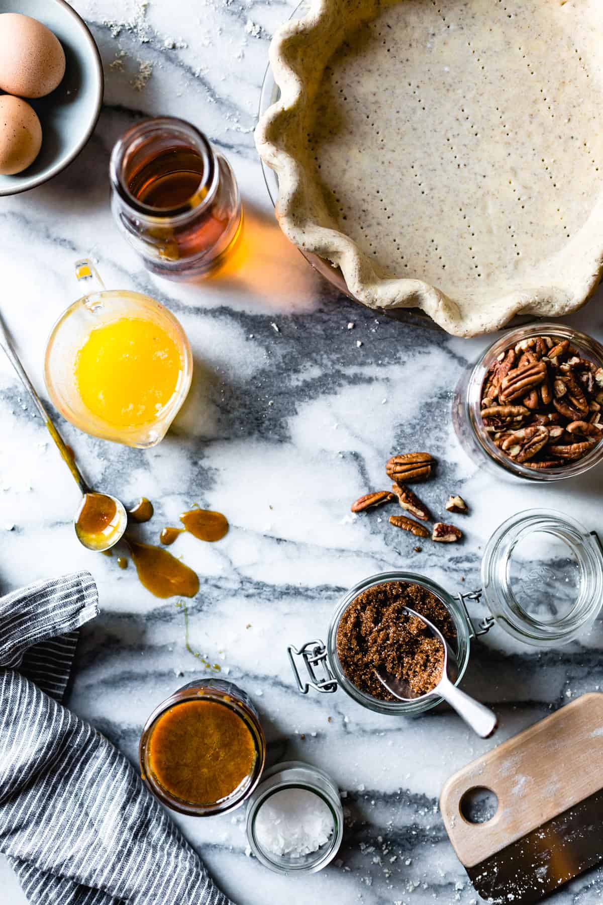 gluten free pie crust and pecan pie ingredients on a marble board