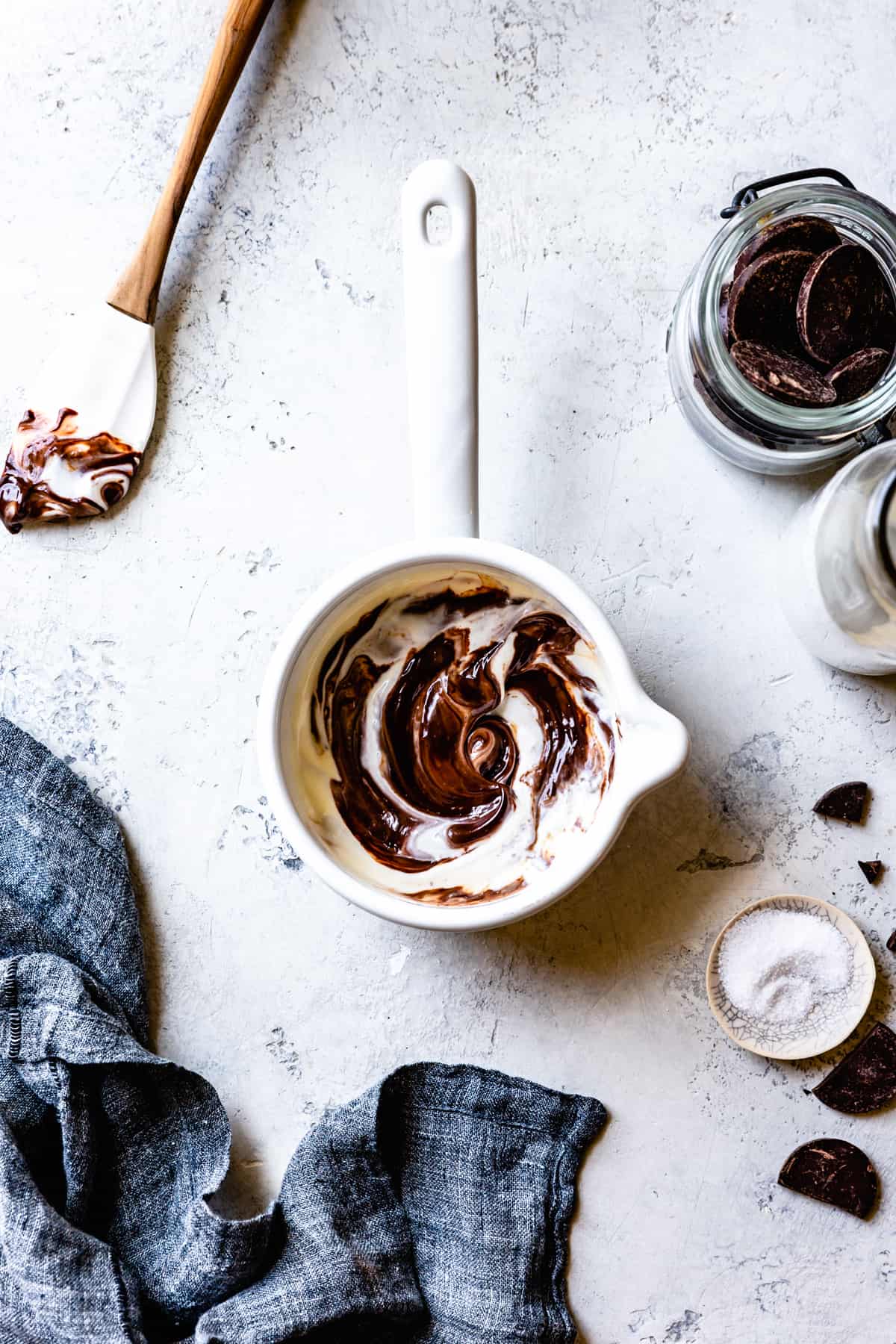 creme fraiche has been swirled into glossy ganache in white enamel pot