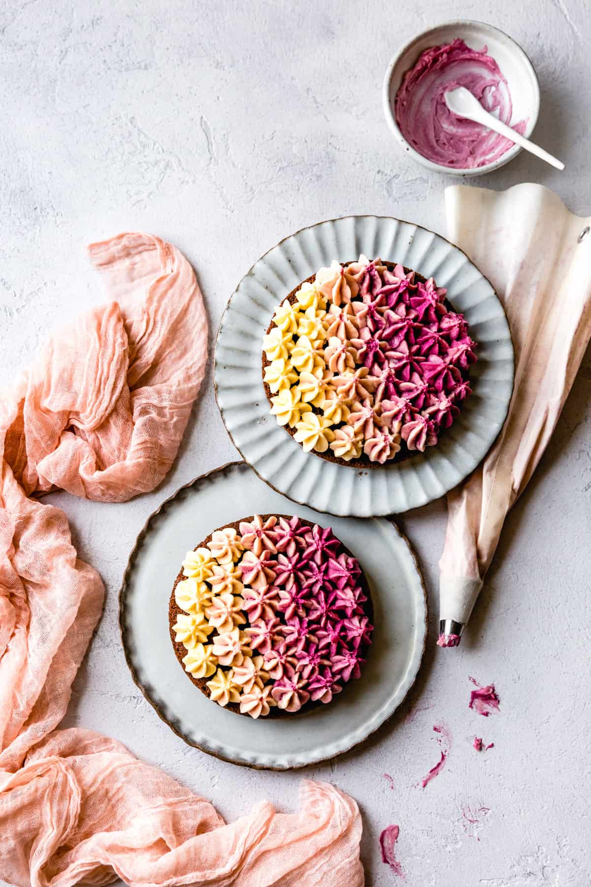 2 Gluten Free Red Velvet Cakes on plates with Beet Ombre Frosting