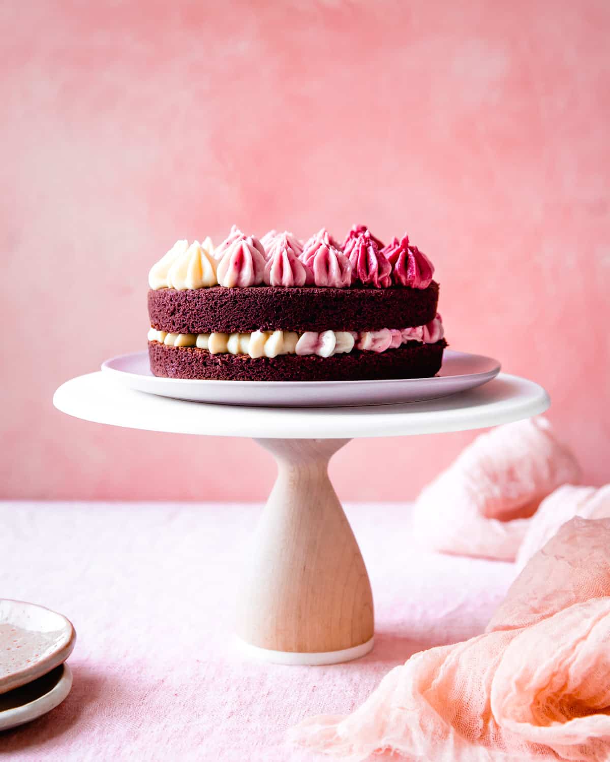 side shot of Red Velvet Cake Recipe (gluten-free, dye-free) on cake stand