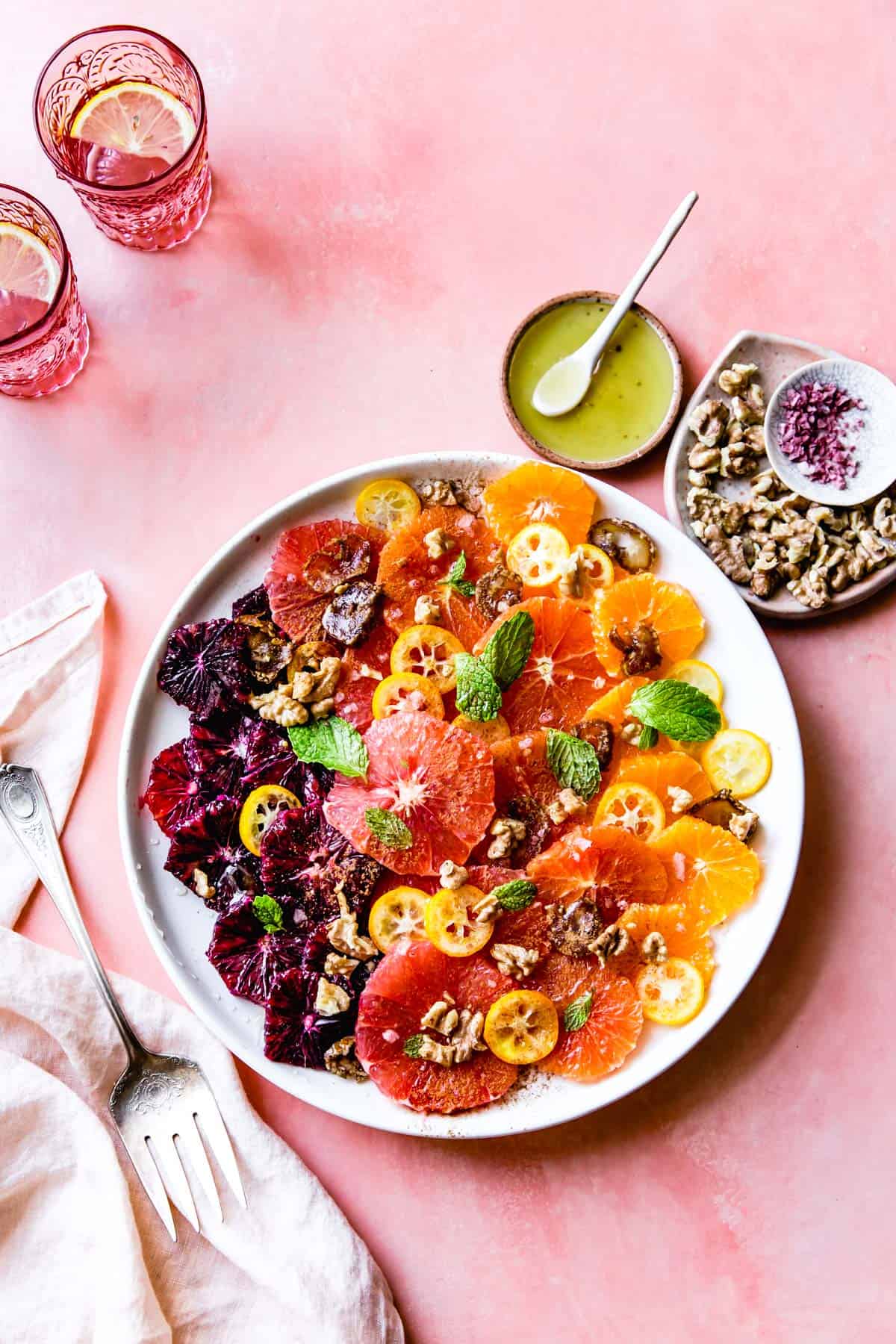 Winter Citrus Fruit Salad with Walnuts, Dates & Rose on a dish